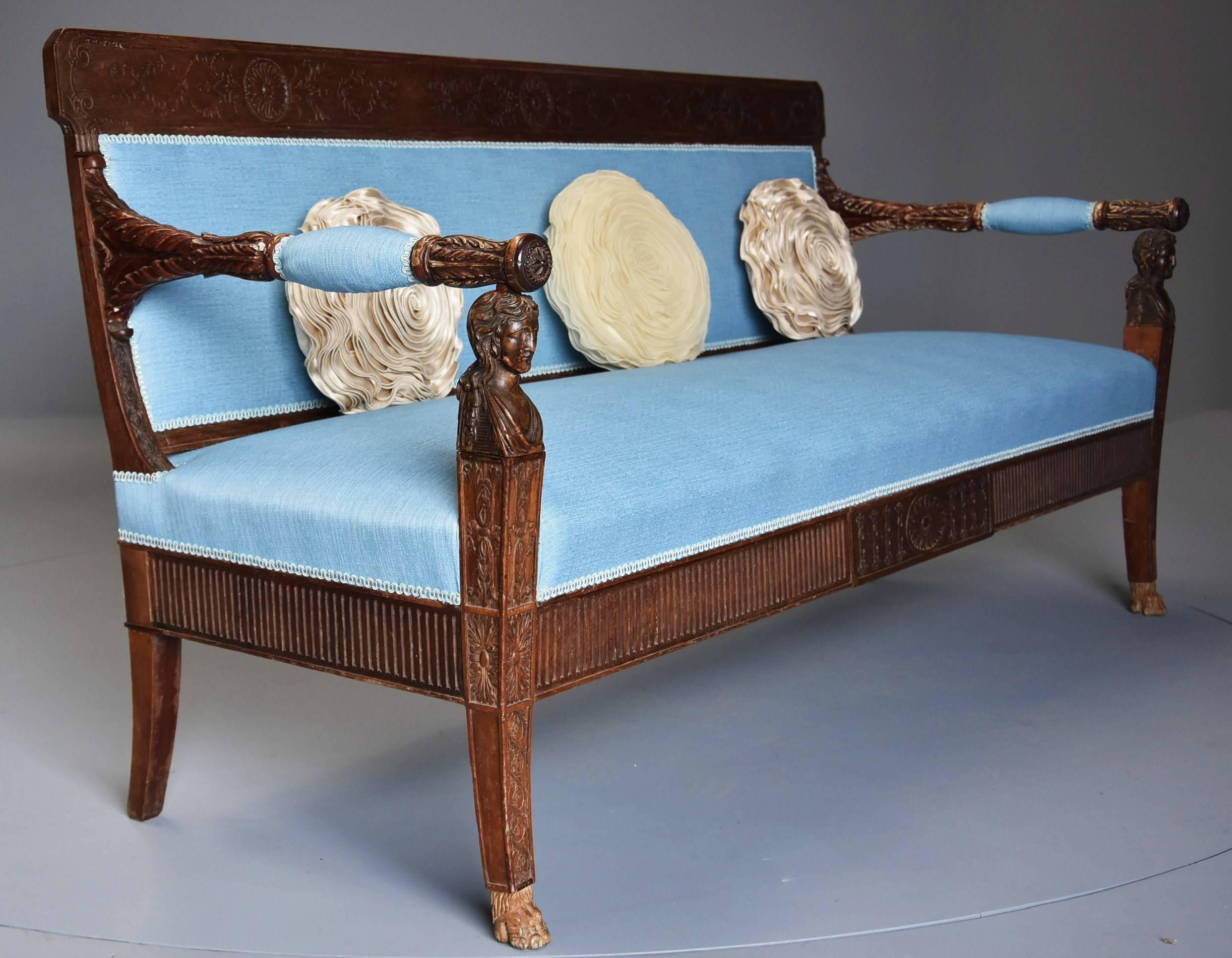 A late 18th century extremely rare walnut Italian sofa or canapé of neoclassical design retaining some of the original polychrome paint finish.

The sofa consists of a top rail finely carved with three medallions with carved foliate decoration