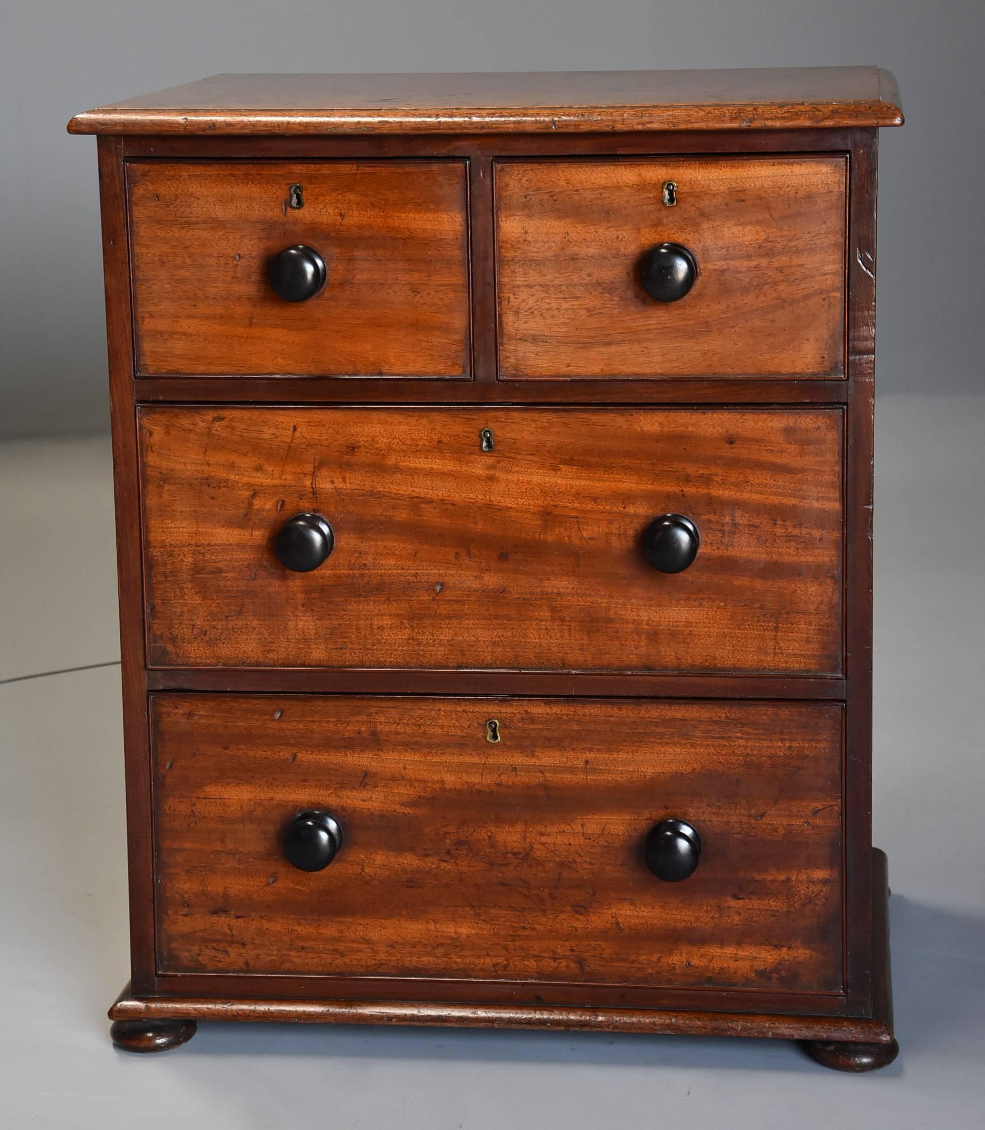 A small mid-19th century mahogany chest of drawers with superb patina.

This chest of drawers consists of a solid mahogany top with moulded edge leading down to two short over two long drawers.

The cockbeaded drawers being oak lined and having
