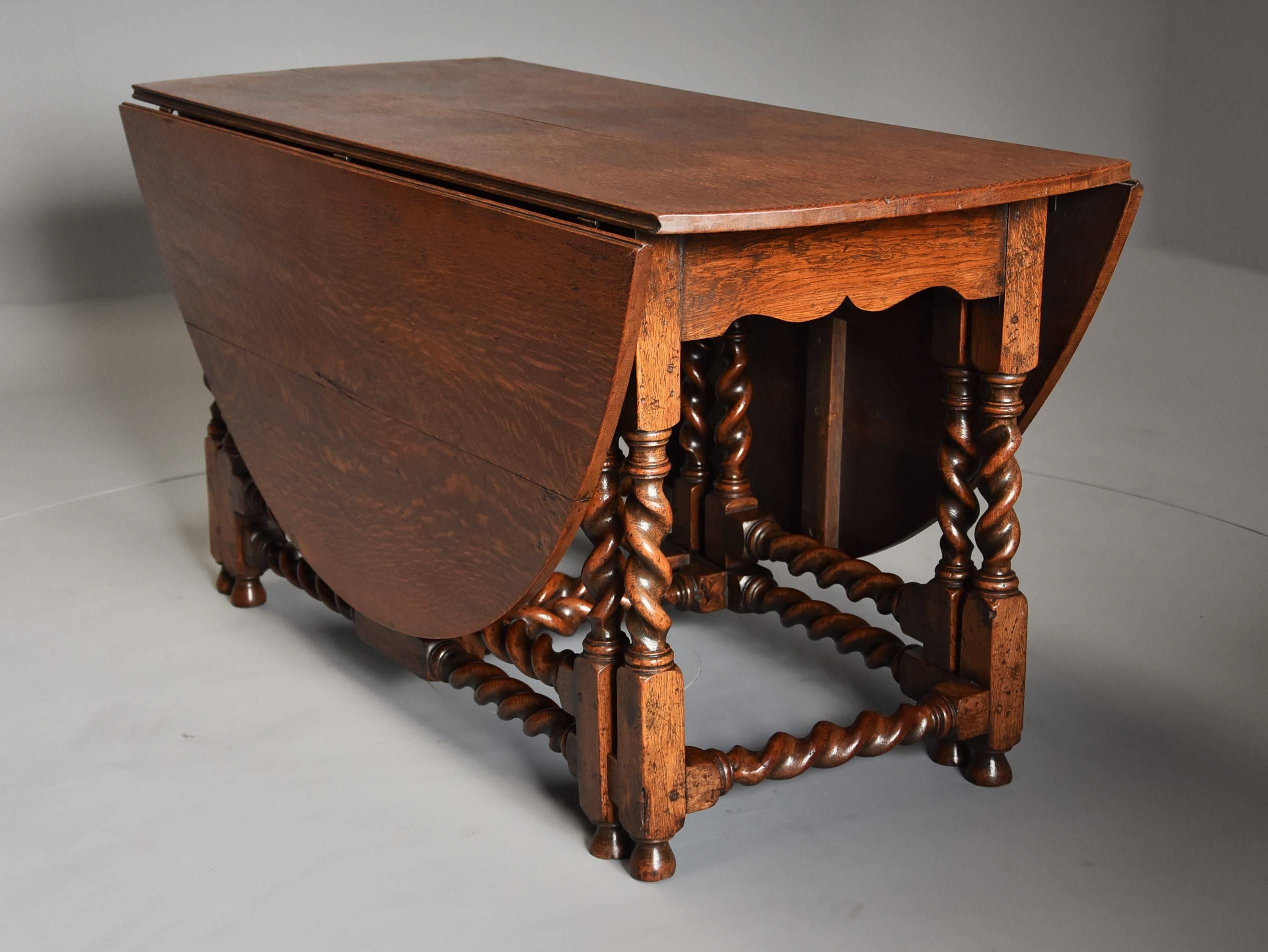 A large late 19th century oak double gate gateleg table.

This large table consists of a solid oak top leading down to barley twist legs and gates (supports) - the double gate makes for a much stronger and more stable construction of table