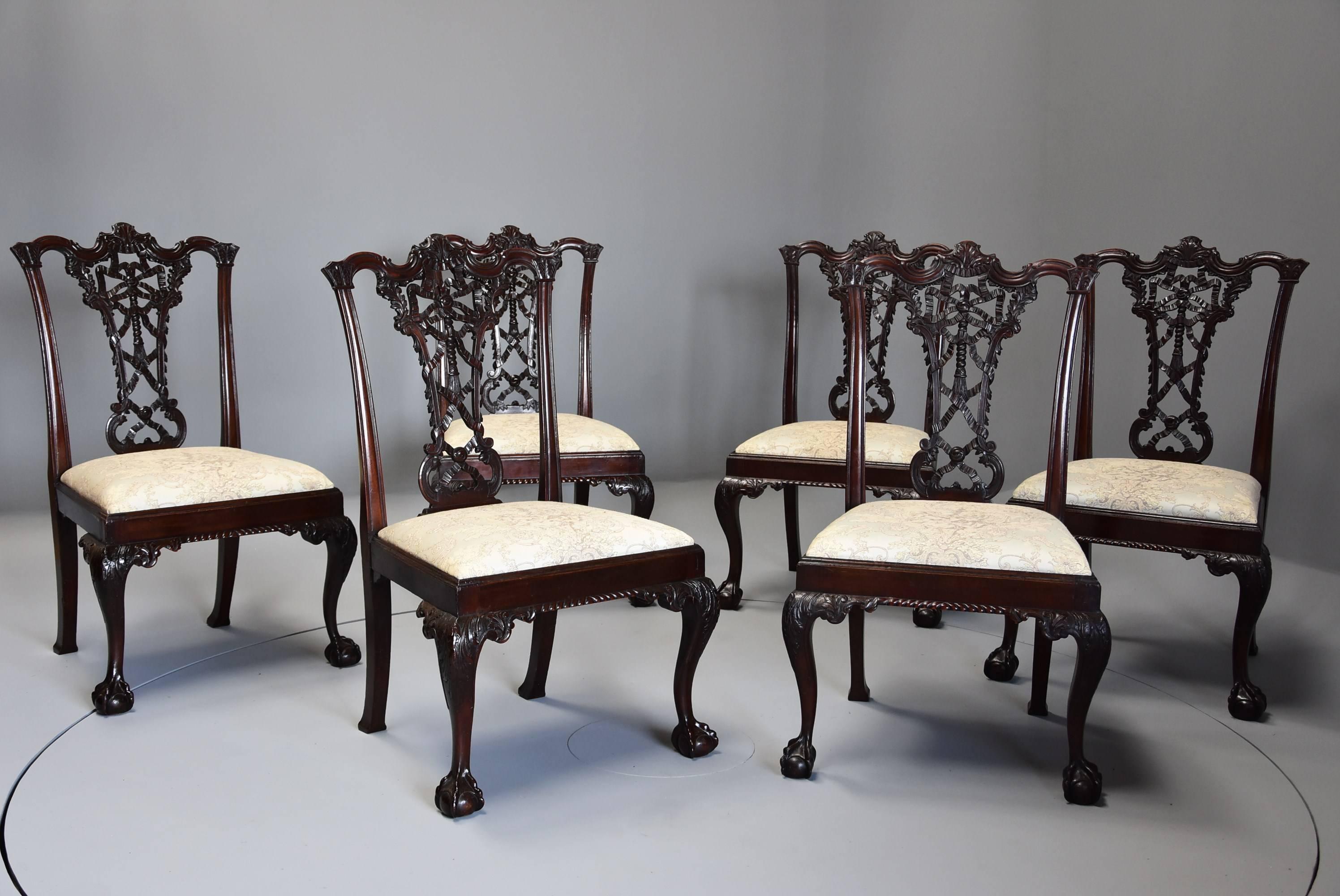 An early 20th century set of six mahogany ribbon back chairs in the Chippendale style.

This set of chairs consist of a shaped and carved top rail with central carved decoration with carved ears to either side leading down to moulded uprights with