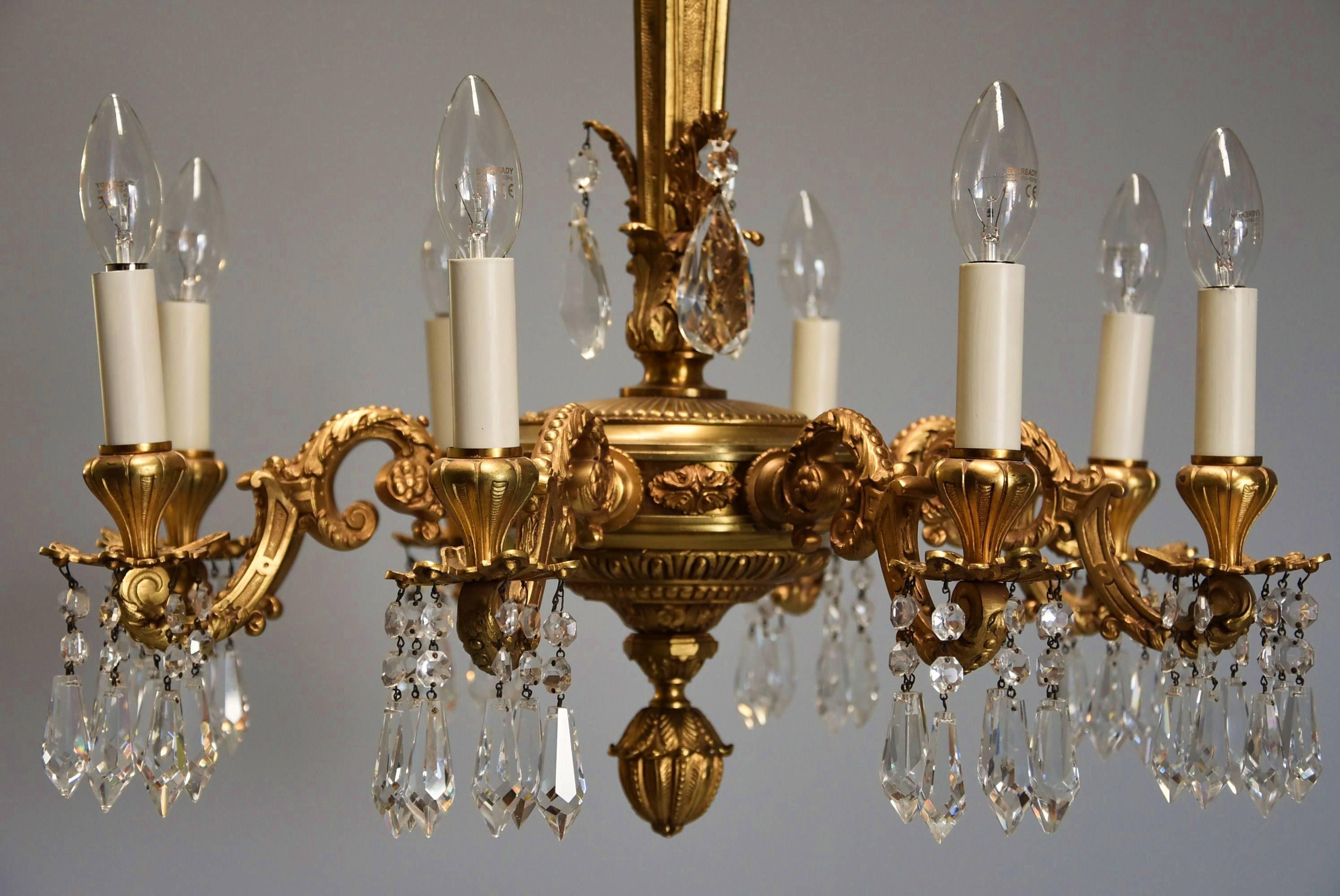 Fine quality French early 20th century eight-branch ormolu and cut-glass chandelier.

A fine quality French early 20th century highly decorative eight branch ormolu and cut-glass chandelier.

This chandelier consists of a central ormolu column