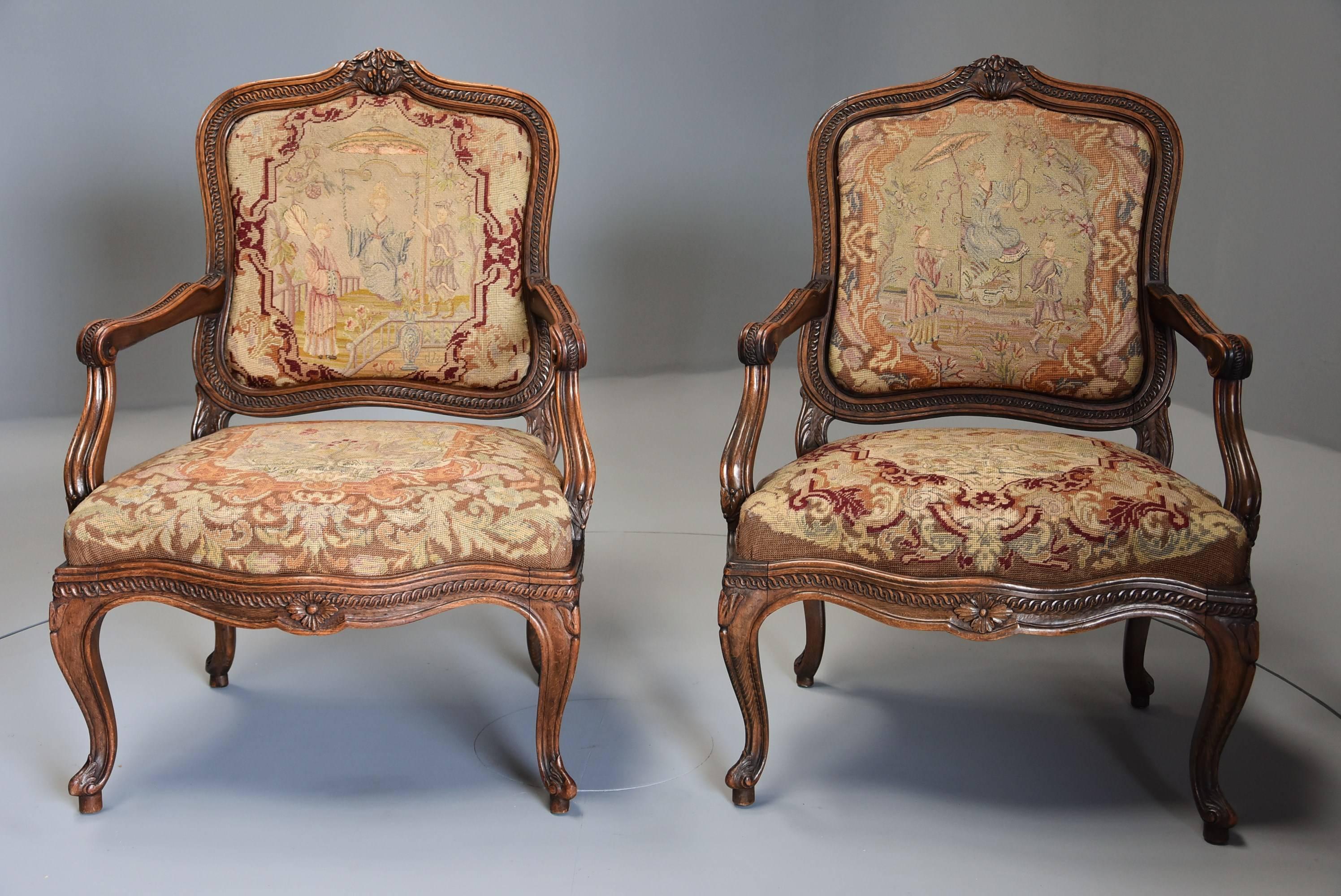 A pair of mid-late 19th century French fauteuils (open armchairs) of large proportion with original needlework.

This pair of chairs consist of stained beech frames, the backs being elaborately carved and shaped with central carved decoration to