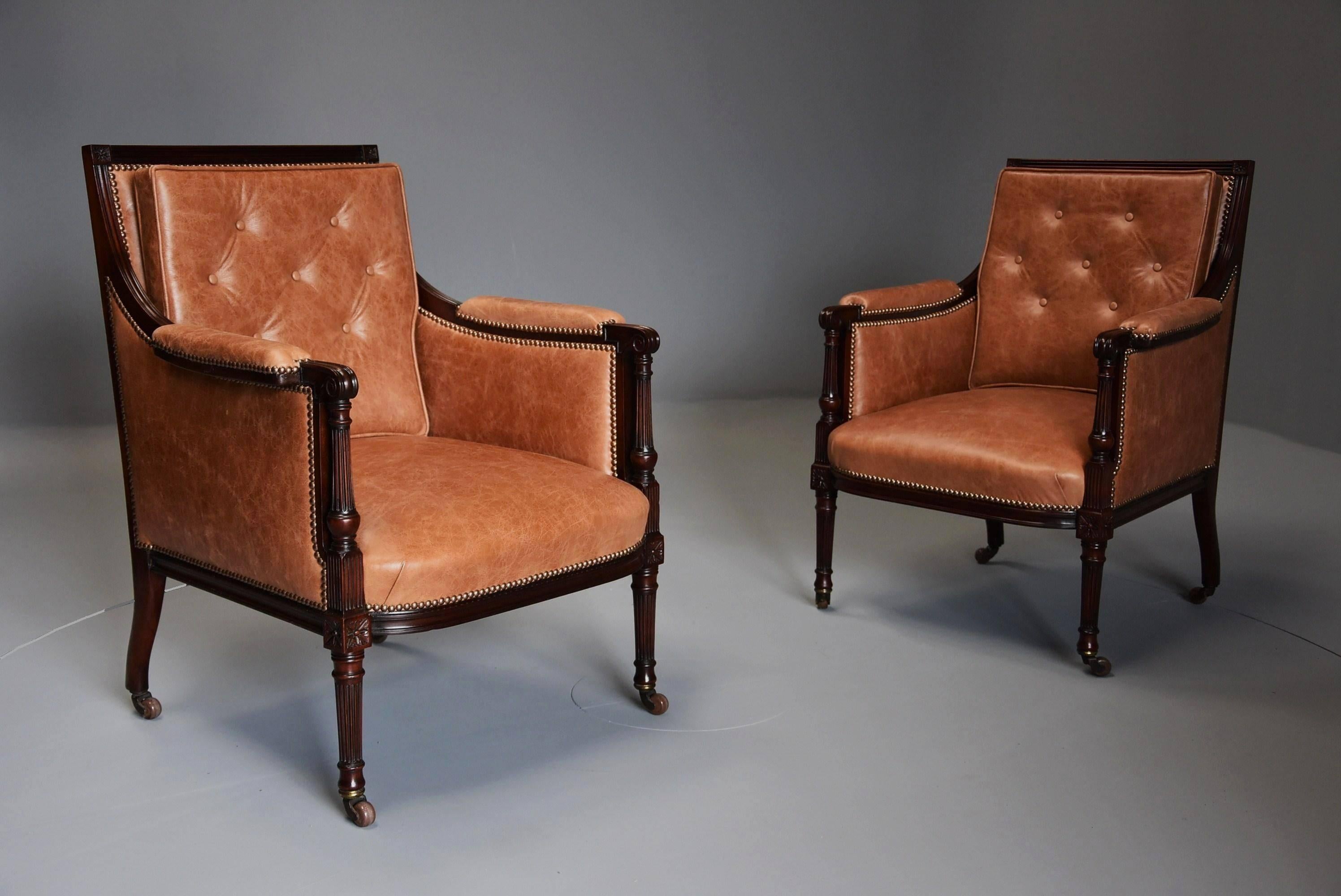 A superb pair of late 19th century ‘His & Hers’ mahogany bergere library chairs in the Sheraton style upholstered in a tan leather retaining retailers plaque 'Morgan & Co, The Hayes, Cardiff'.

These chairs consist of a square moulded top rail