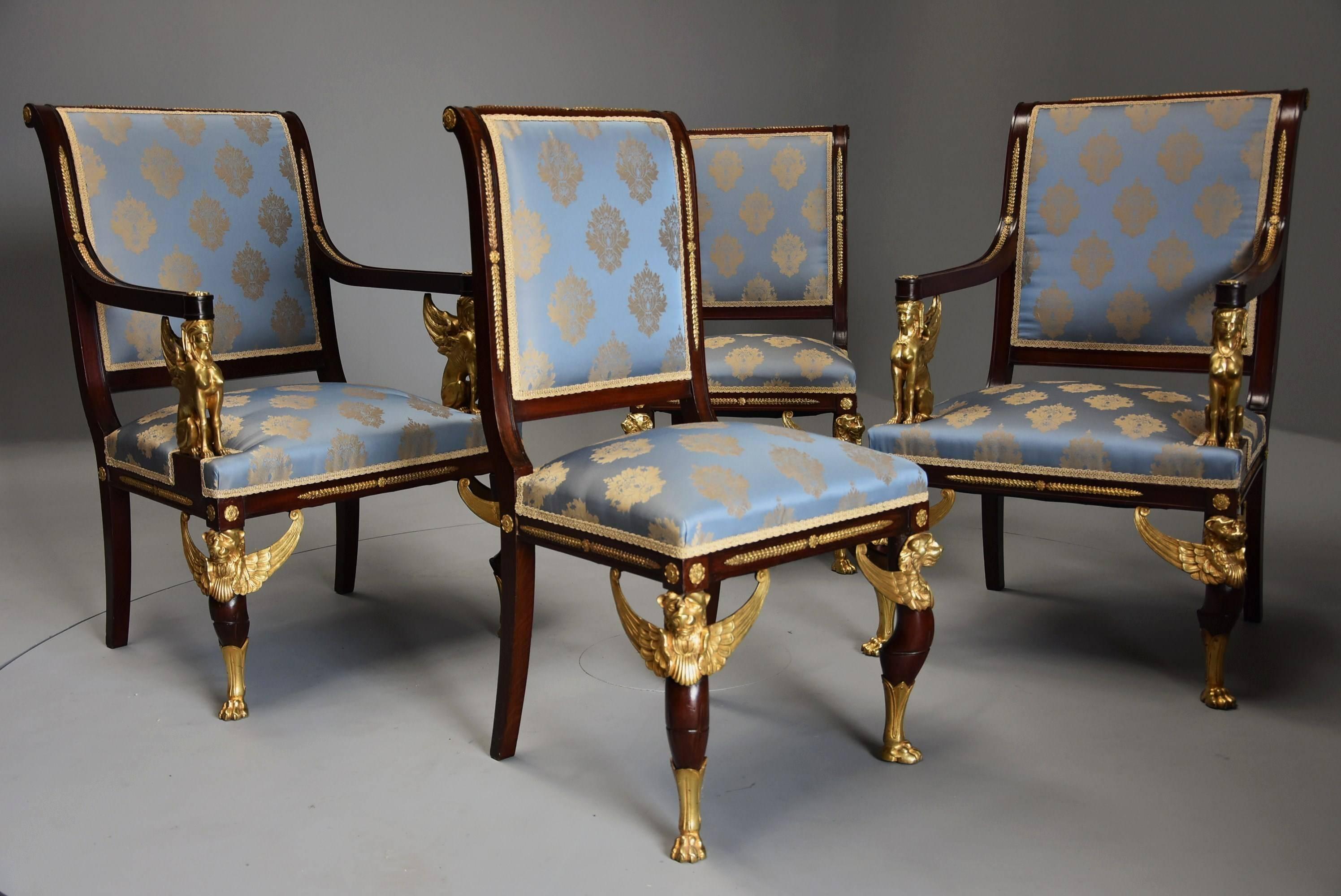 An excellent quality late 19th century set of four highly decorative English mahogany chairs in the French Empire style with superb ormolu mounts by EH Kahn & Co, London.

This set of chairs consists of of two armchairs and two single chairs
