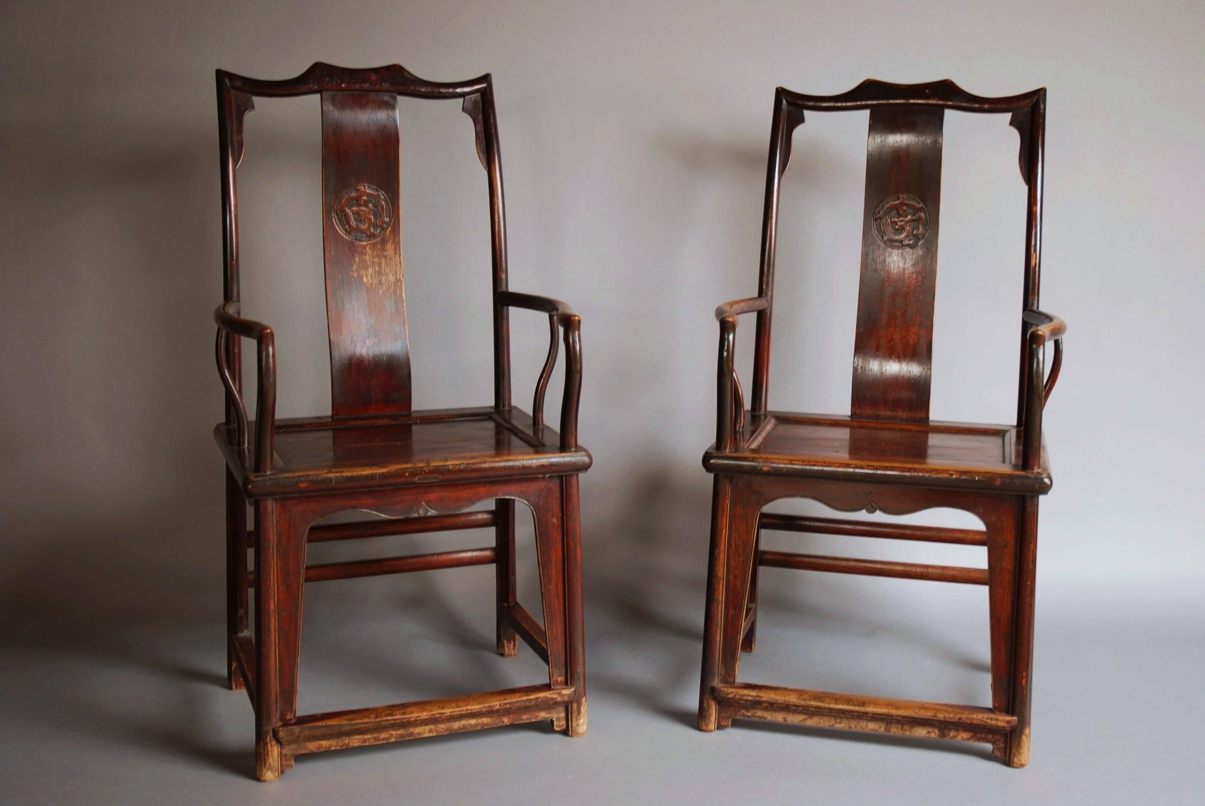 A pair of late 19th century Chinese yoke back elm armchairs of good patina. 

This type of chair are one of the earliest chair designs recorded in China, the high back design symbolizes wealth and grandeur to both the owner and any person invited