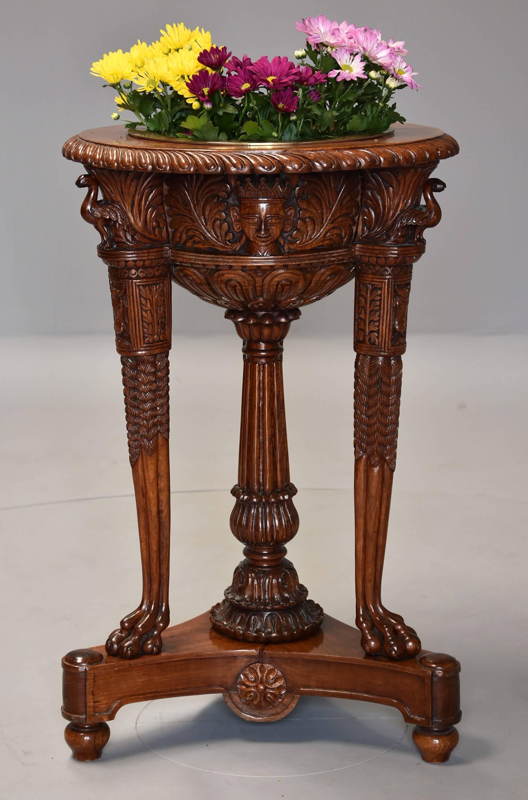 A late 19th-early 20th century highly decorative Indian hardwood carved jardiniere or wine cooler.

This jardiniere consists of a circular top with recessed brass liner (this can be used for either flowers or as a wine cooler) with carved gadroon