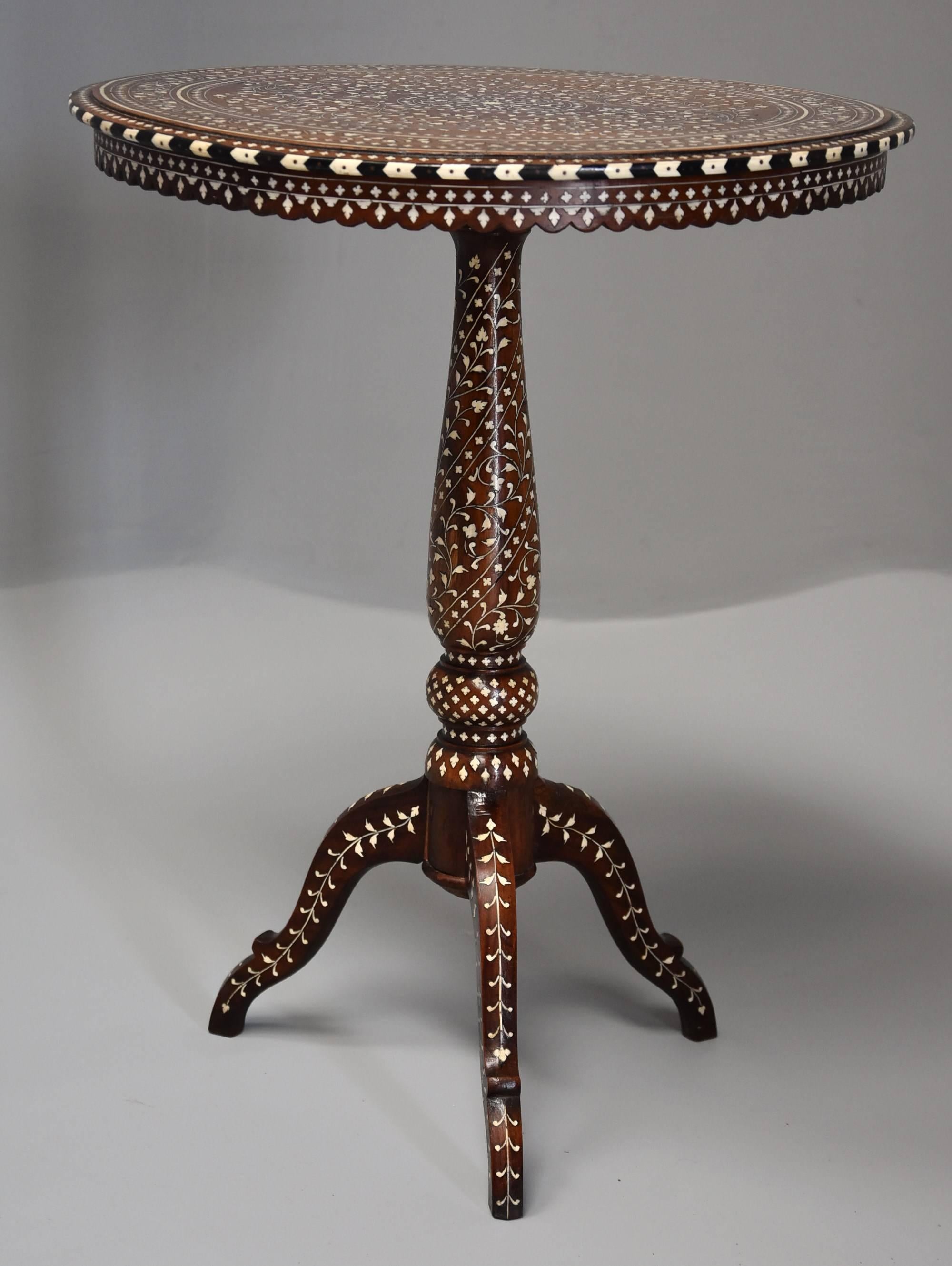 A superb quality late 19th century Anglo-Indian circular shisham wood inlaid occasional table from the Hoshiarpur region in India.

This table consists of a circular top with profusely inlaid ivory decoration of foliate and quatrefoil designs with