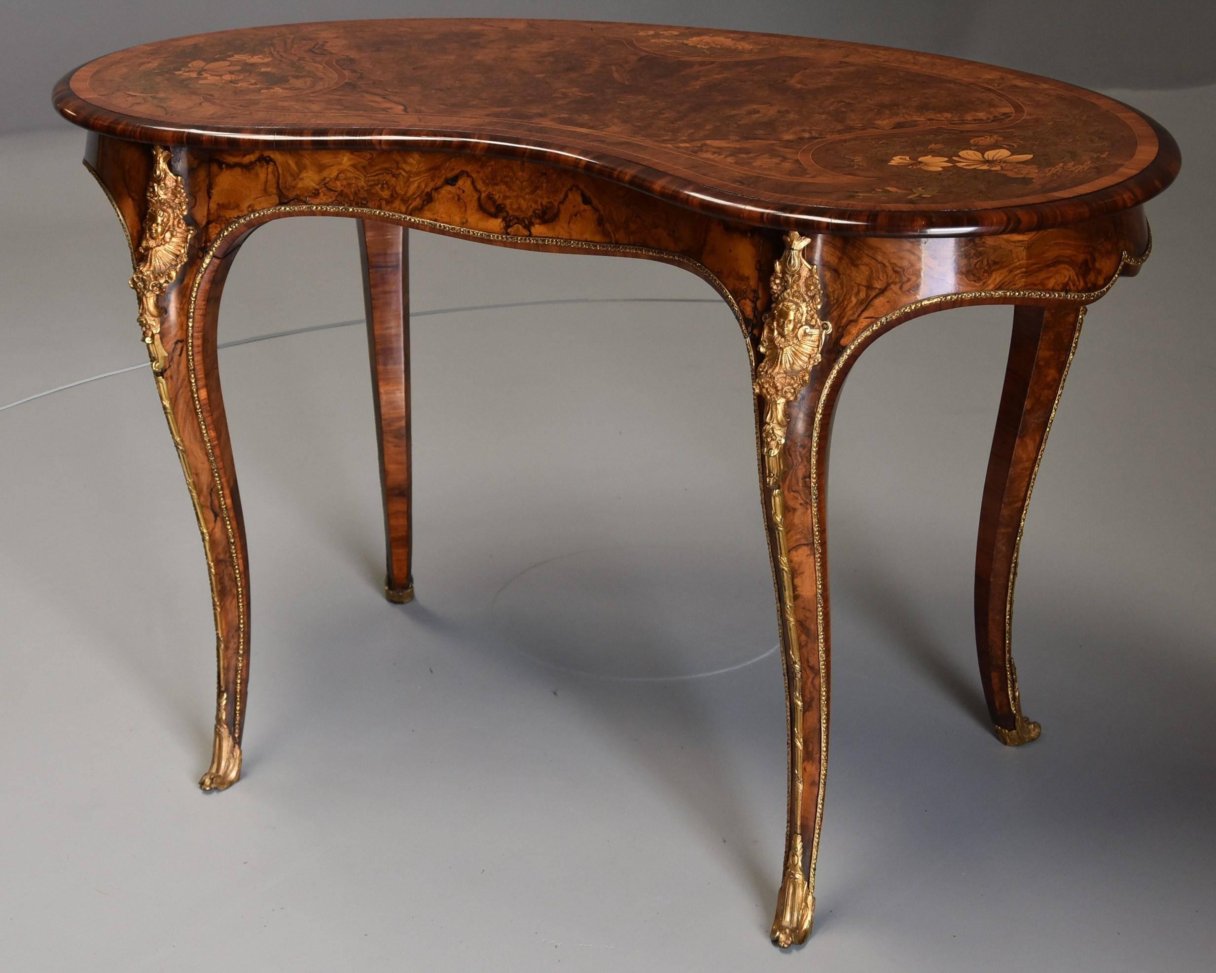 A superb quality mid-19th century burr walnut and marquetry freestanding kidney shaped table in the manner of Gillows.

This wonderful table consists of a kidney shaped top with superbly figured burr walnut mirror veneered shaped central panel