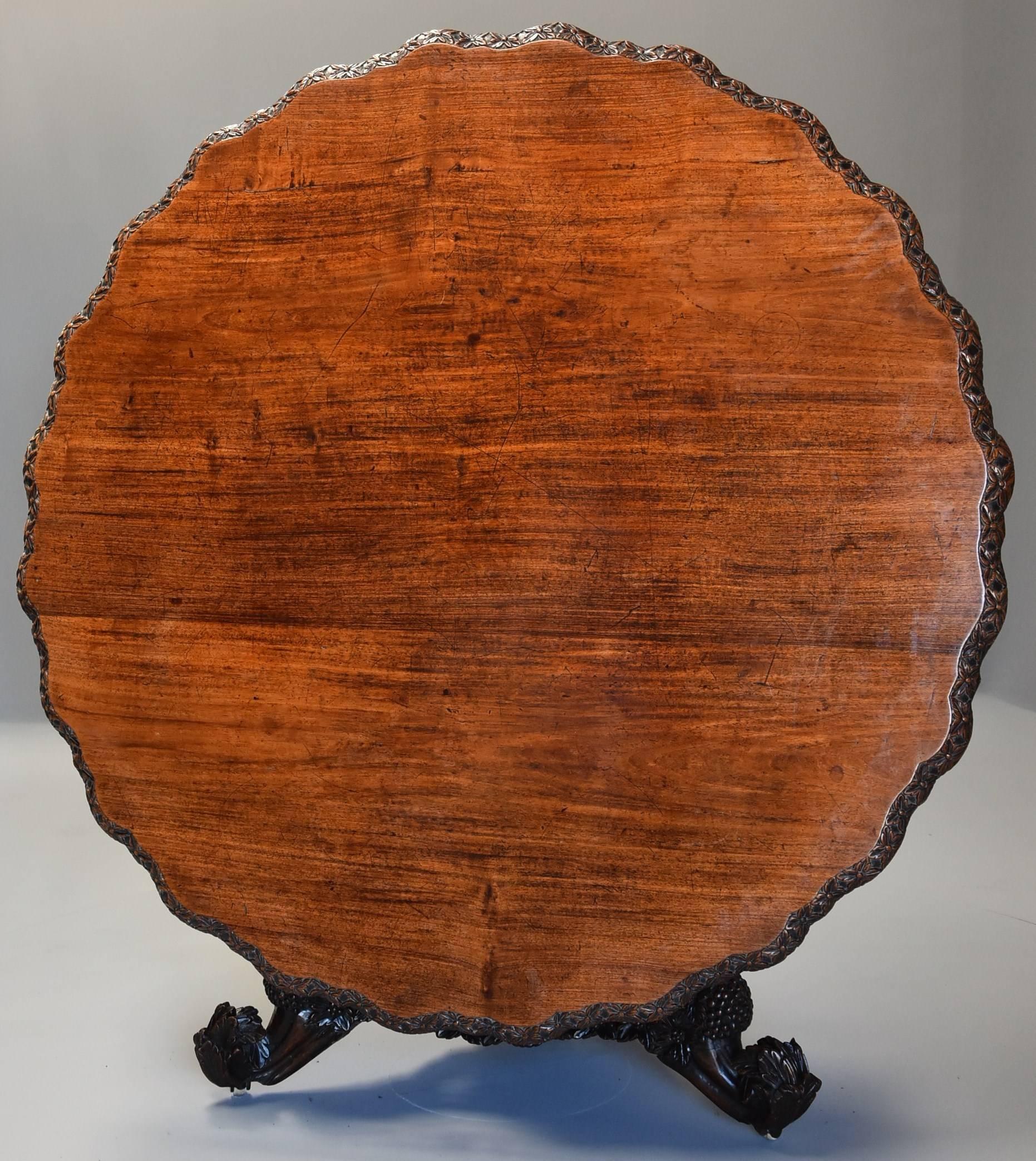 A large highly decorative mid-19th century Anglo Indian hardwood centre table of circular form and with superb original patina from the Bombay area of India.

This table consists of a shaped superbly figured and well patinated solid padouk top of