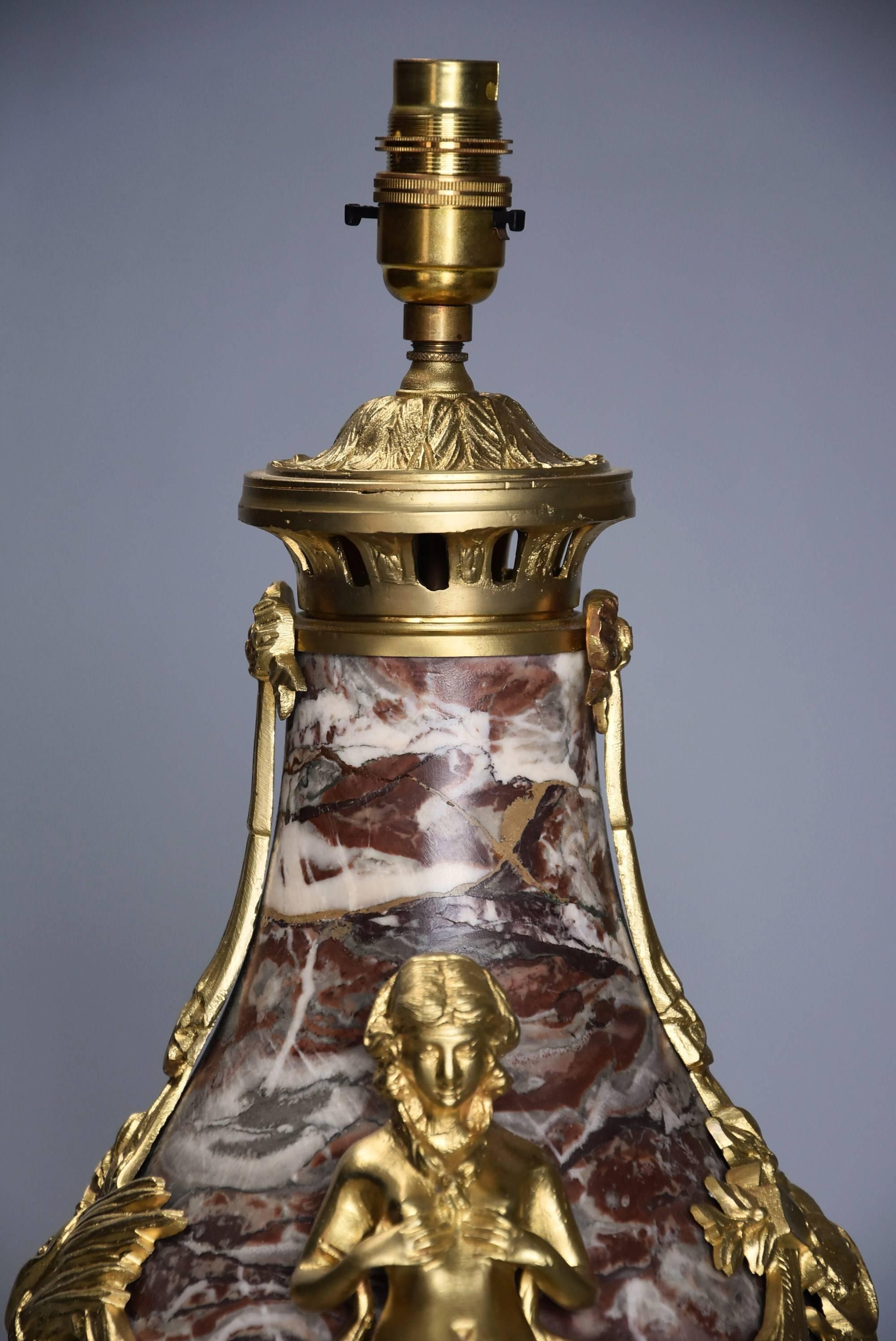 A large fine quality late 19th century French marble table lamp with ormolu embellishments

This highly decorative lamp consists of a vase shaped marble base with fine quality ormolu fittings of leaf design to the top leading down to ribbon and