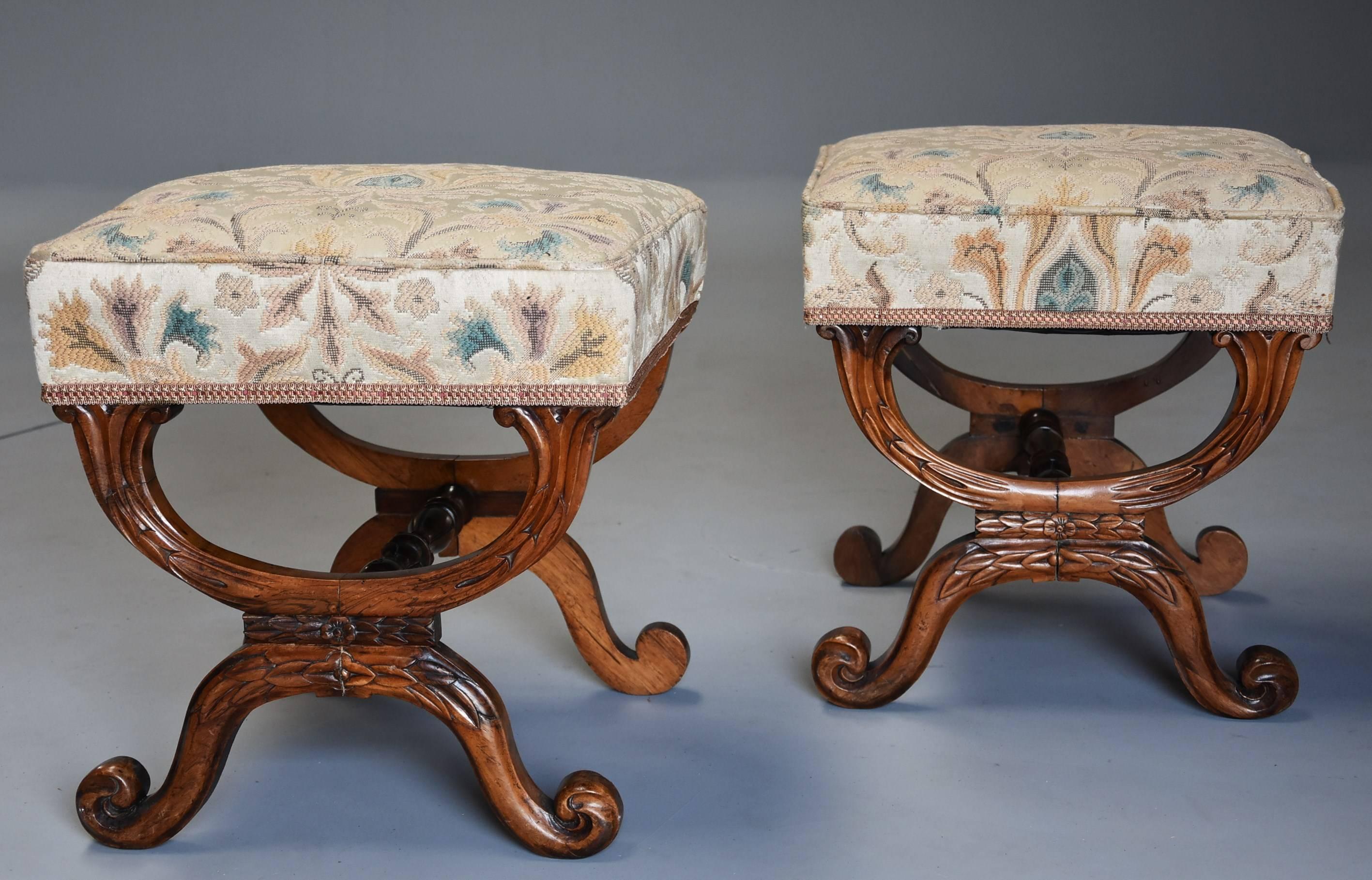 A pair of 19th century William IV (circa 1840) rosewood X-frame upholstered stools.

This pair of stools consist of upholstered seats finished in a tapestry style fabric with piping and braid, the upholstery in very good condition.

These lead