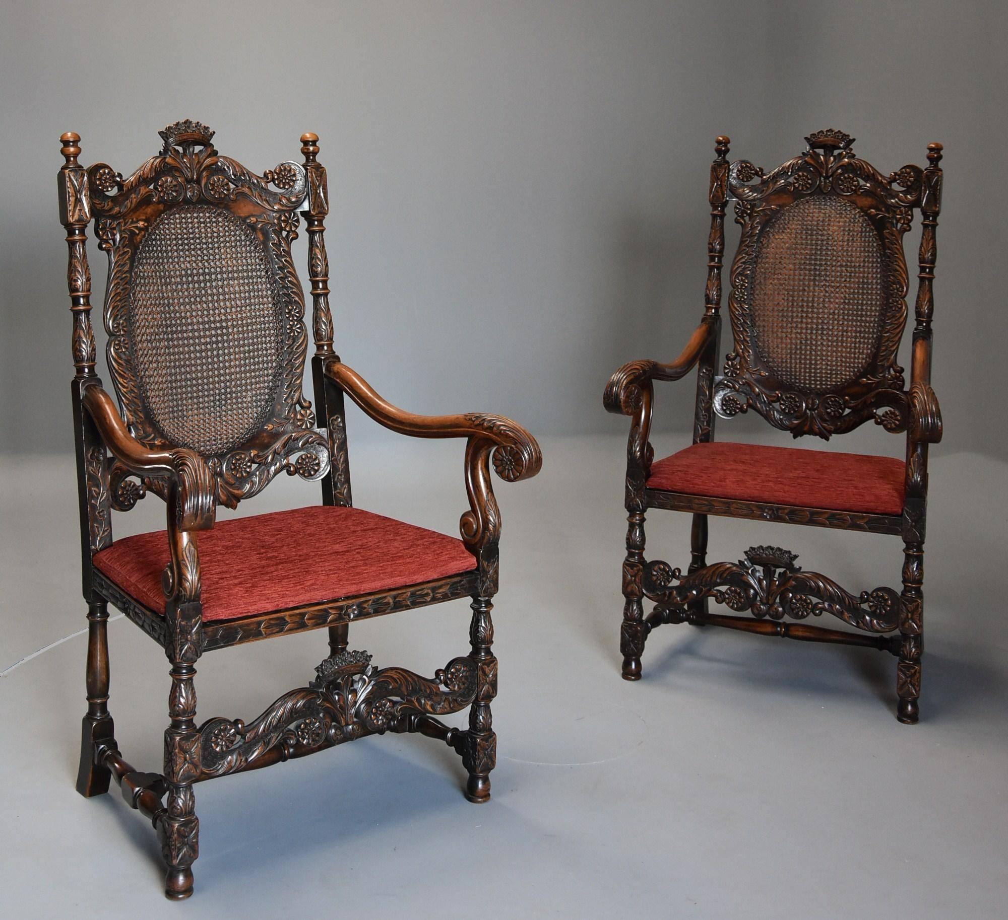 A superb pair of early 20th century Charles II or Carolean style walnut armchairs of substantial proportions.

This pair of chairs consist of a superbly carved top rail with crown of flowers to the centre, carved scrolling foliate decoration