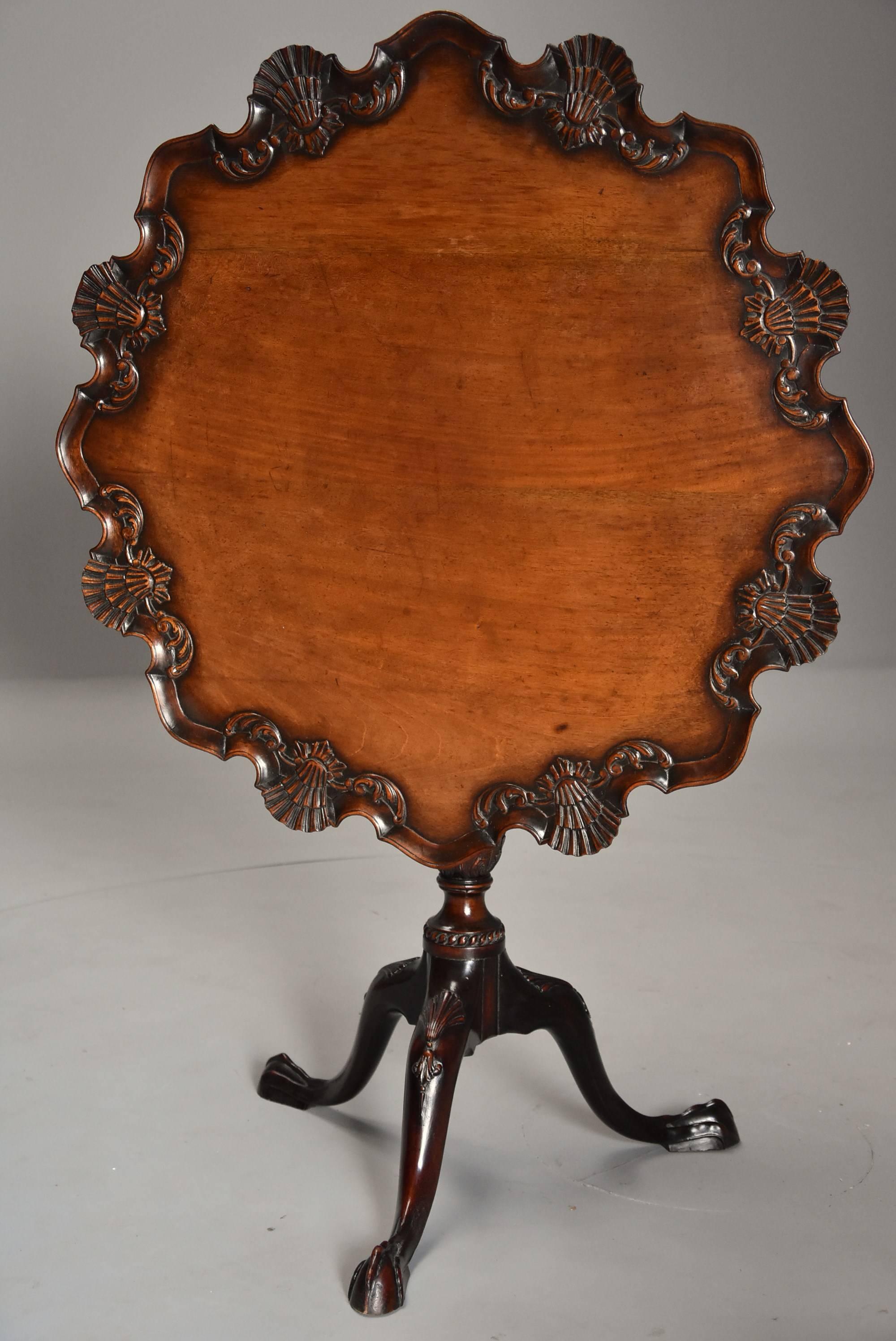 A late 19th century superb quality Chippendale style mahogany piecrust tilt top tea table with tripod base.

This table consists of a mahogany top of good patina (color) with applied scallop shell and foliate carved decoration with applied