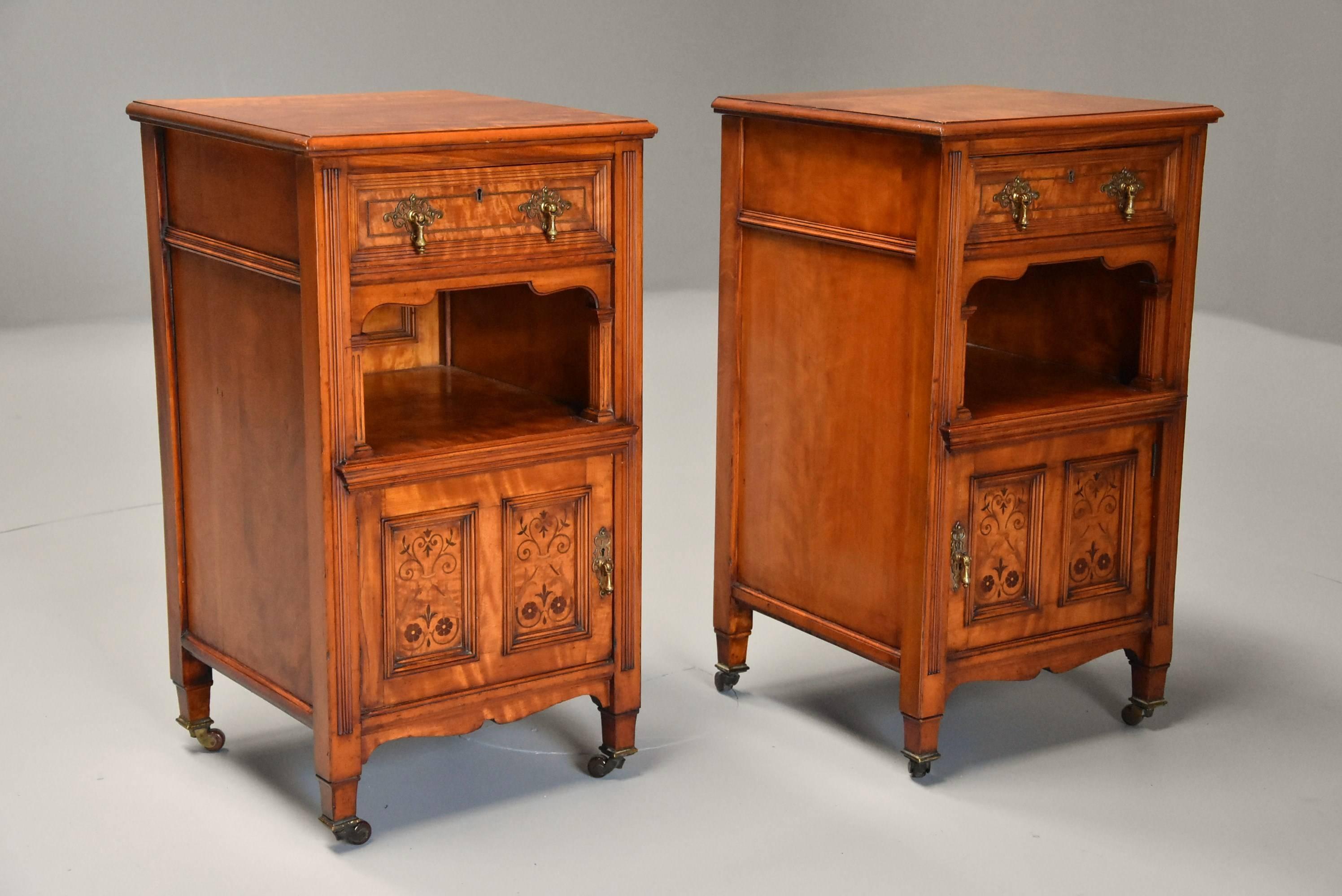 A pair of late 19th century satin birch bedside cabinets with influences of the Aesthetic Movement. 

This pair of cabinets consist of satin birch tops with a moulded edge leading down to a mahogany lined drawer, the drawer fronts with a moulding