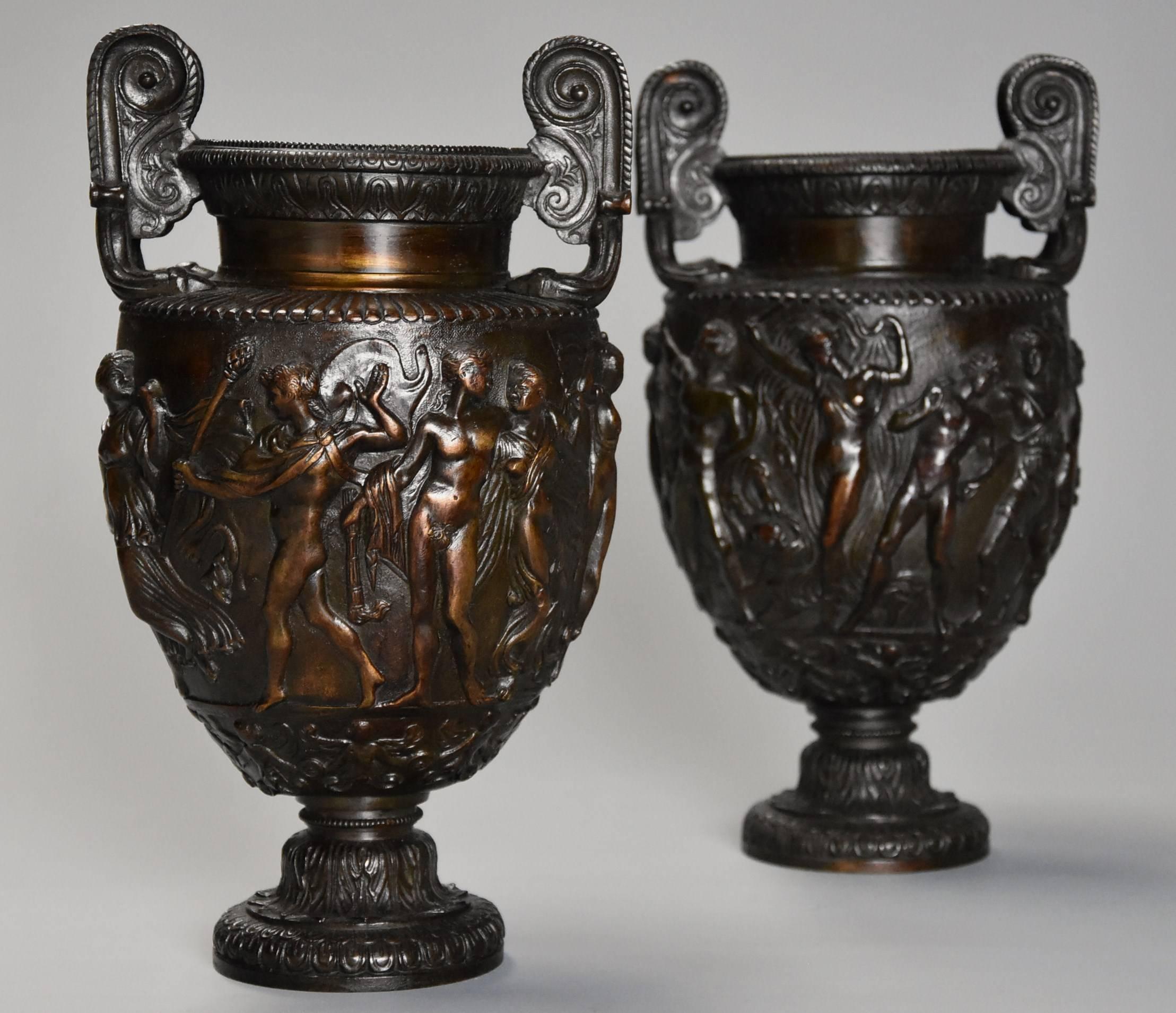 A pair of highly decorative mid-19th century Grand Tour bronze 'Townley Vases' with good patination based on the original Roman marble vase of the same name.

This pair of bronze vases consist of volute handles to either side in the manner of a