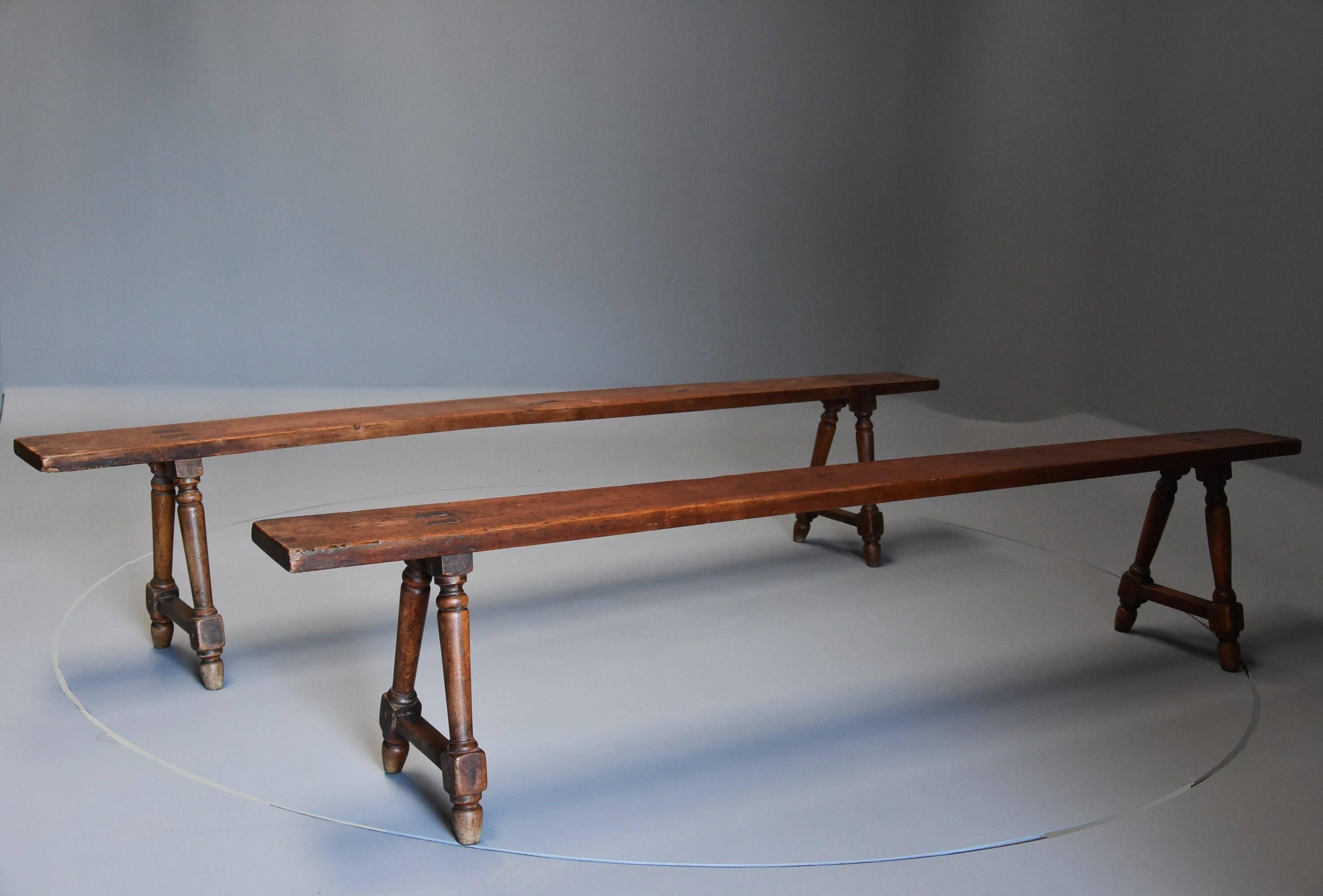 A pair of mid-19th century French fruitwood (cherry) benches of superb patina (colour).

This pair of benches, all of solid cherry, consist of long tops (or seats) supported by turned legs and stretchers.

These benches are in excellent original