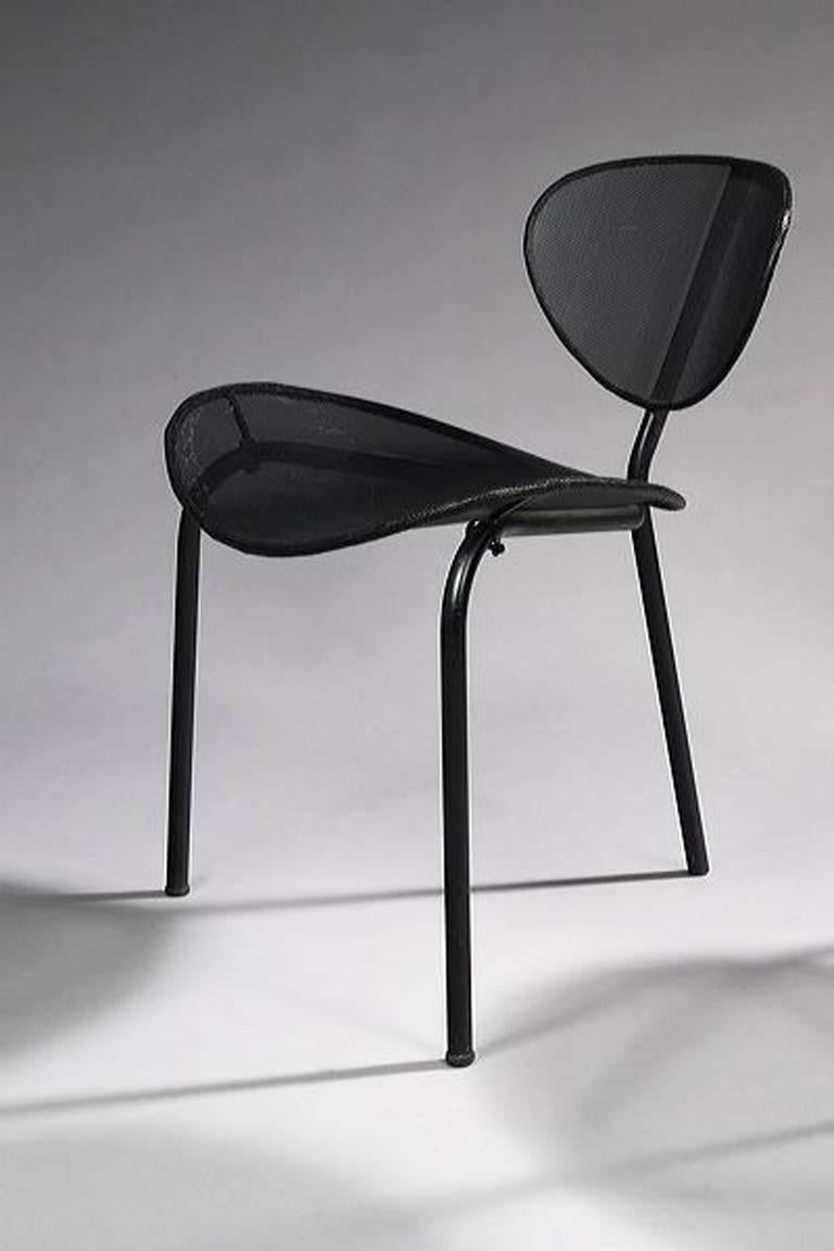 With dished perforated seat and back, on tubular metal tripod frame. Originally black painted.

Comment : A 