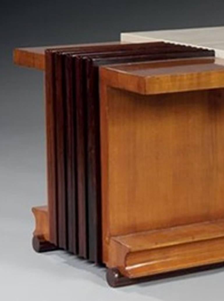 Marcel Genèvrière and André Domin for Maison Dominique.

Cherrywood and wide grooves of mahogany around the rectangular plateau.
The central part raised composed of two sheathed sliding parts of parchment opens on a subwoofer in oak.
Base in