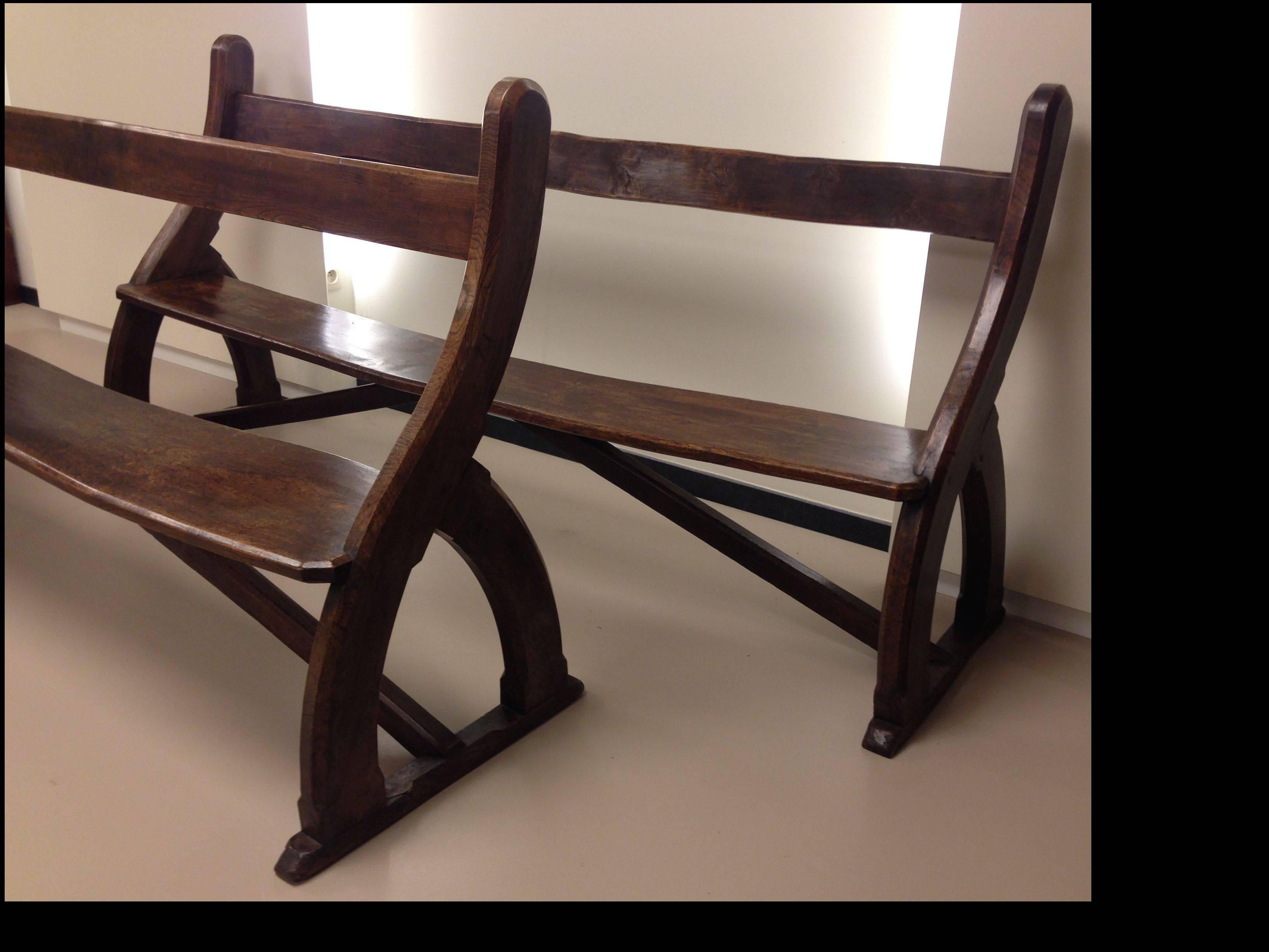 Two Gothic design elm chamfered frame pews or benches, attributed to Hardman & Company, Birmingham and A. W. N. Pugin
Each with a plank horizontal back and seat within scroll outline and pointed arch shaped end supports, on sledge