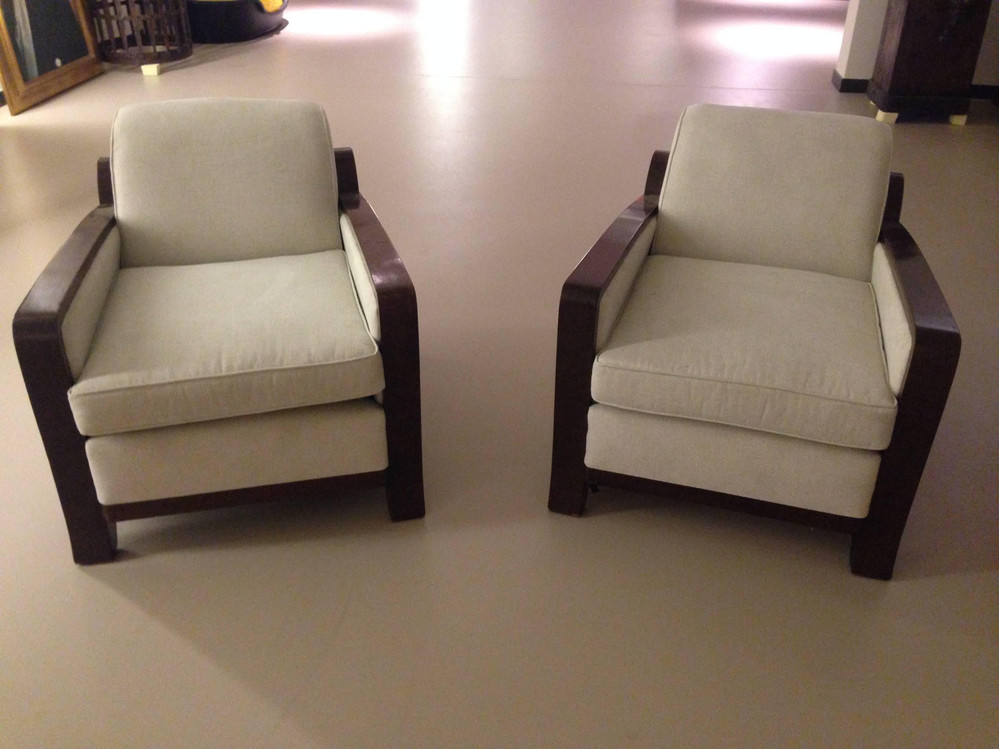 A pair of Art Deco armchairs,
early 20th century.
Figured mahogany and upholstery, each with a curved raked back and squab cushion.