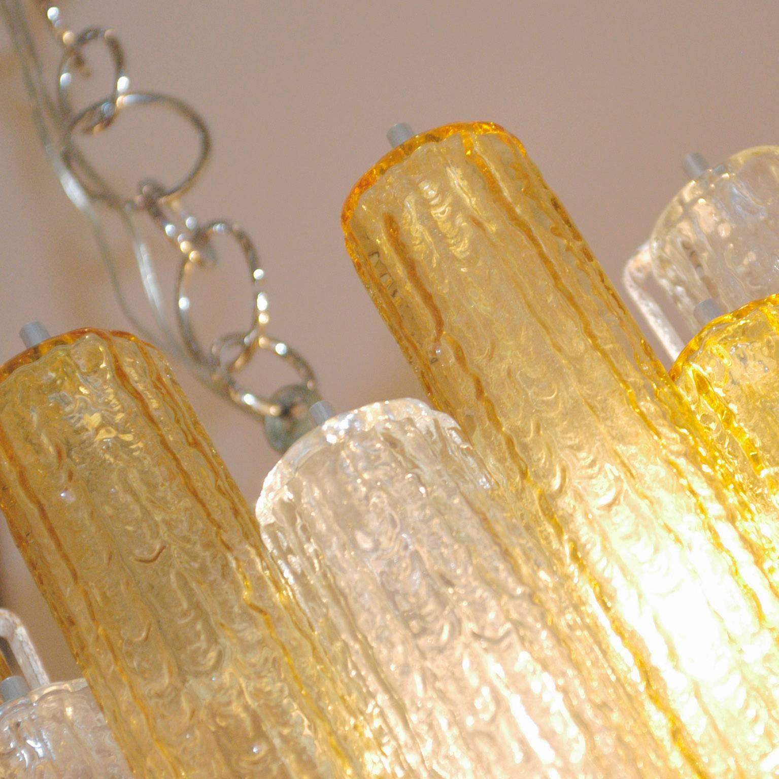 Fantastic two-tone clear and yellow- tronchi Murano chandelier.
Absolutely fantastic big glasses with in 18.1 / 46 cm length and dm in 2.4 / 6 cm.
Nine E14 light sockets.
 