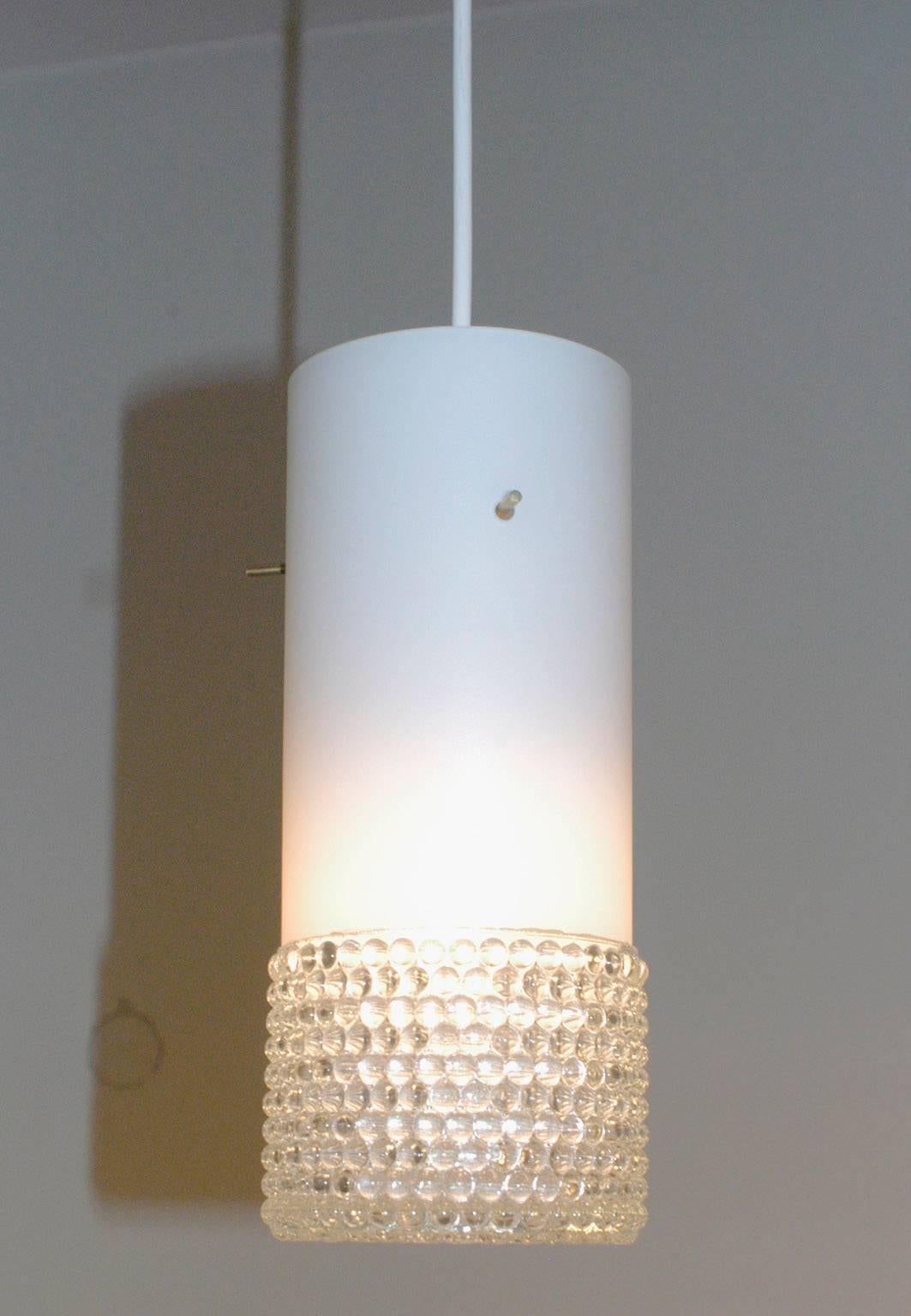 Set of three cylindrical opaline and bubble glass pendant lights with brass fittings, probably manufactured by Staff Leuchten Germany in the 1960s.