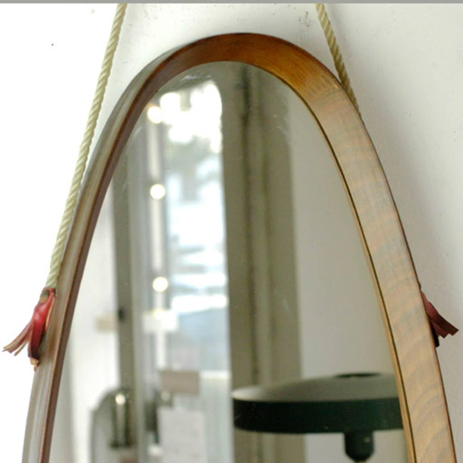 Italian wooden oval mirror with cord.