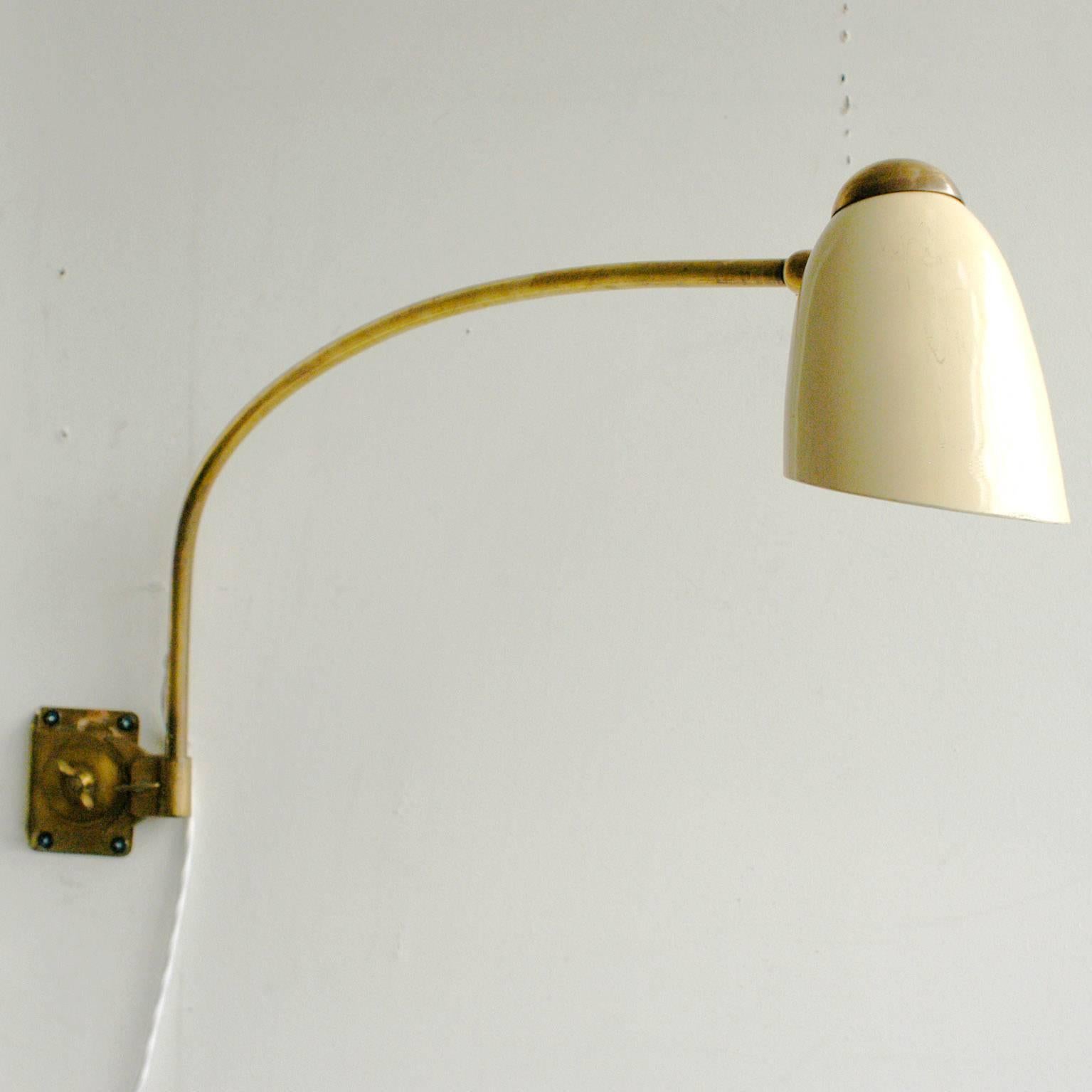 Elegant Italian modern adjustable brass wall lamp.