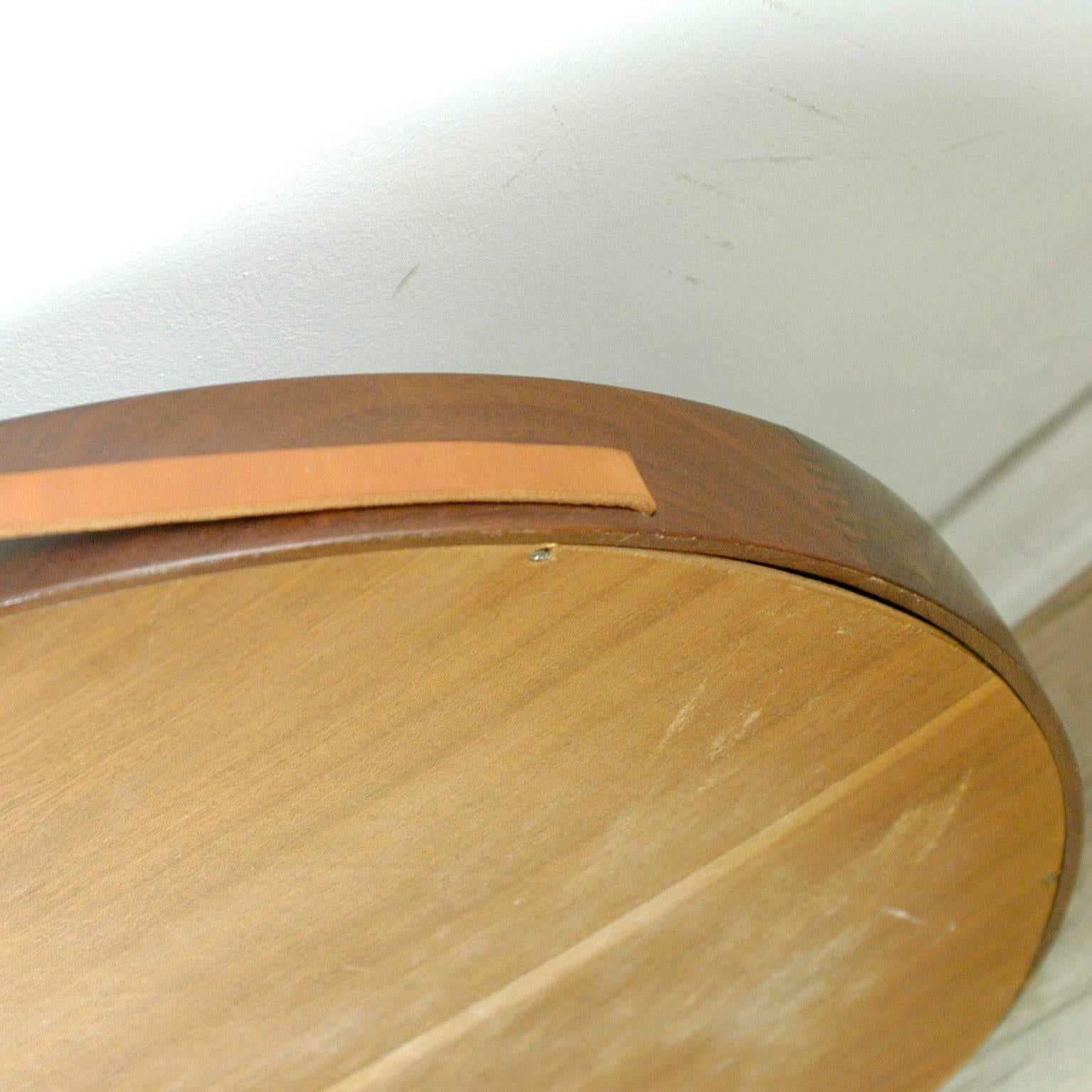 Scandinavian modern circular rosewood wall mirror in excellent craftmanship with leather strap designed by Uno and Osten Kristiansson for Luxus Vittsjö Sweden.