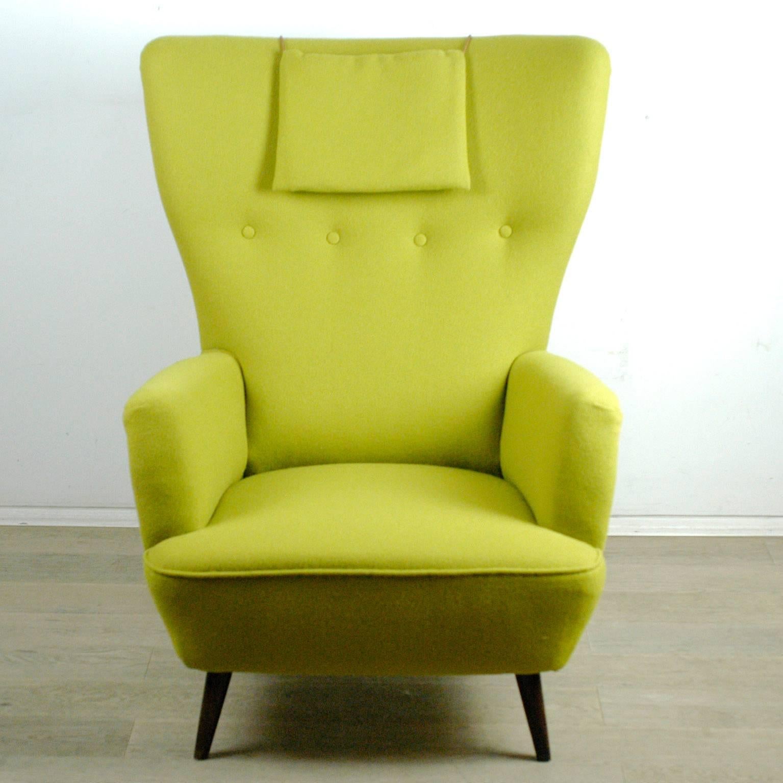 Highly comfortable Austrian 1950s highback Armchair with walnut legs, new upholstery with top quality Kvadrat fabric.