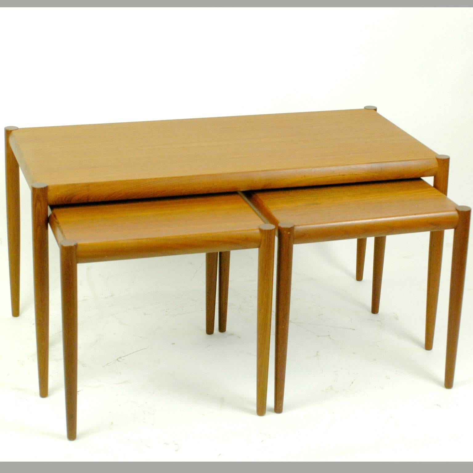 Amazing set of Scandinavian Modern teak nesting tables from the 1960s, two have same size, fitting under the third bigger one.