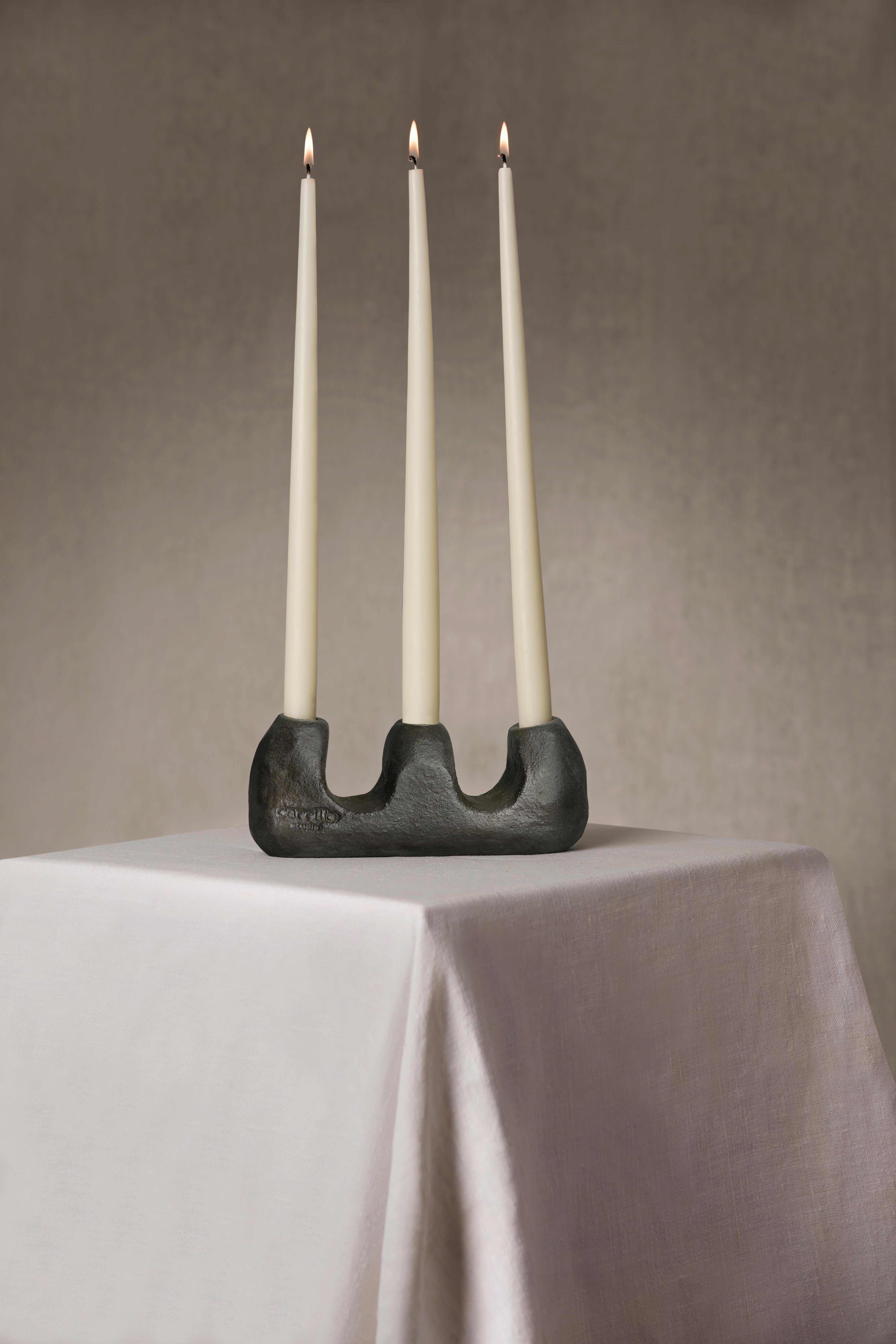 Lumière & Hombre is a sculptural pair of candleholders, hand-built in grogged black stoneware and burnished with natural wax to reveal their raw, earthy texture. Crafted by Irene Sánchez Carrillo in her Barcelona studio, these pieces reflect a deep