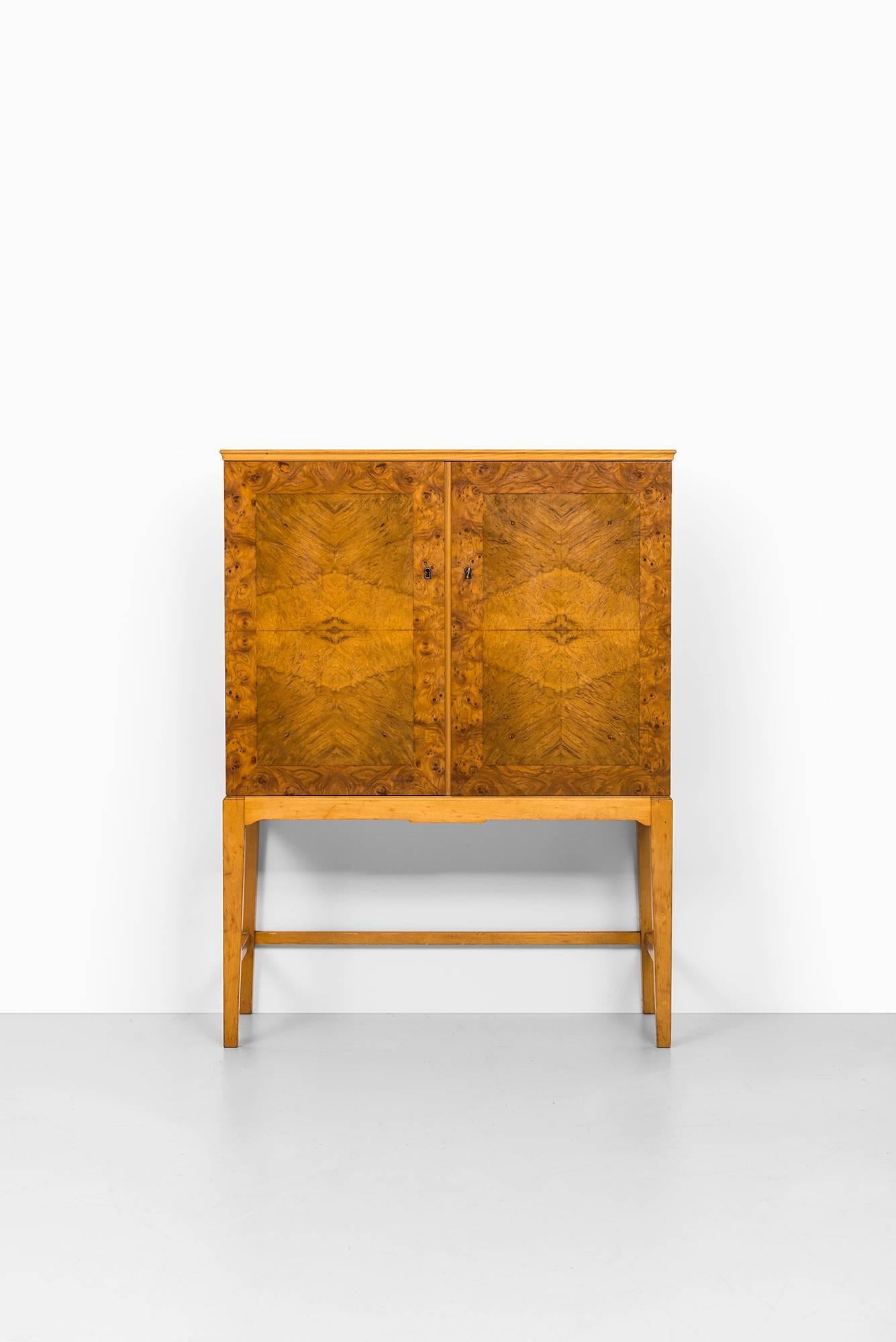Mid-Century cabinet in burl wood produced in Finland.