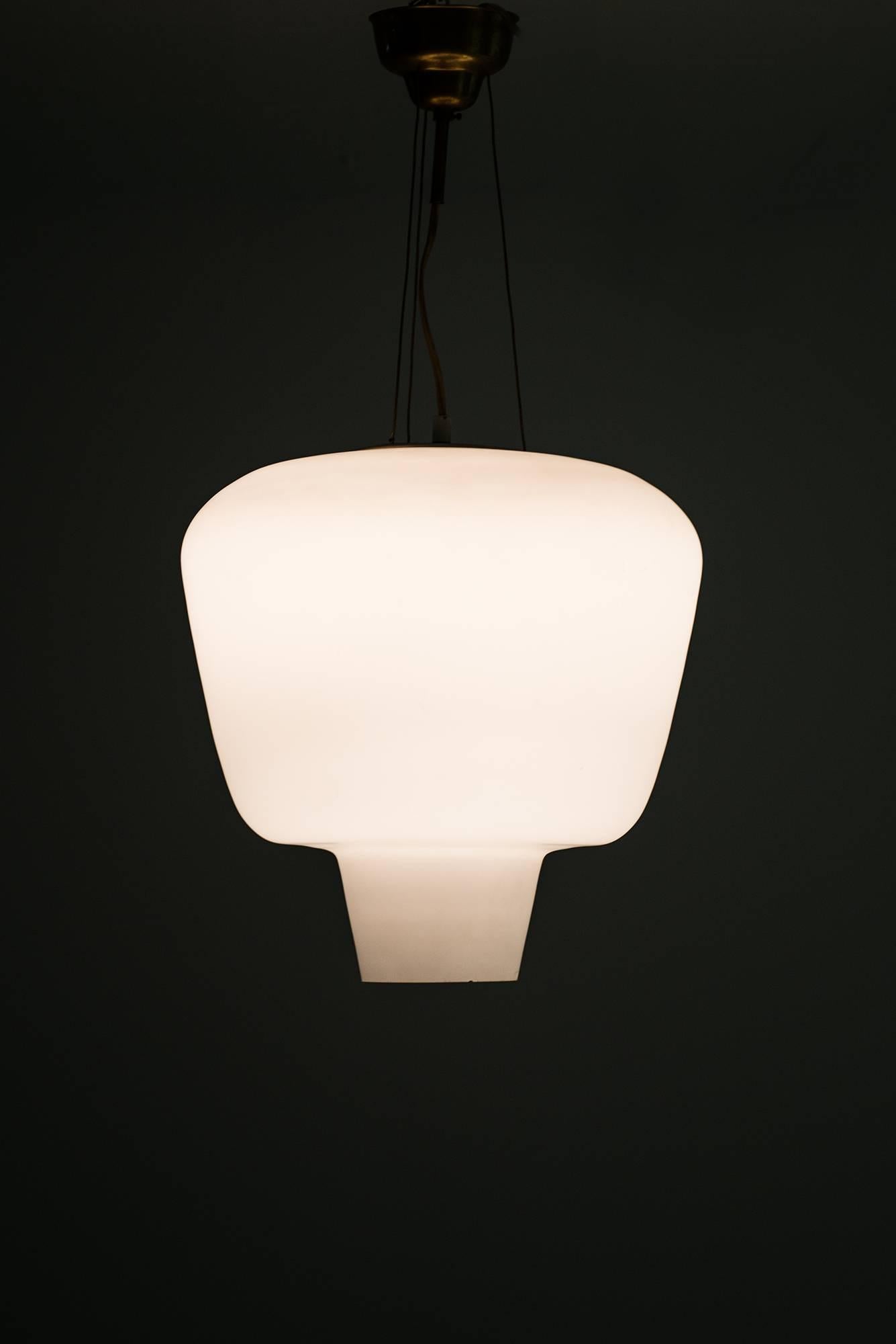 Rare ceiling lamp in opaline glass and brass. Produced by ASEA in Sweden.