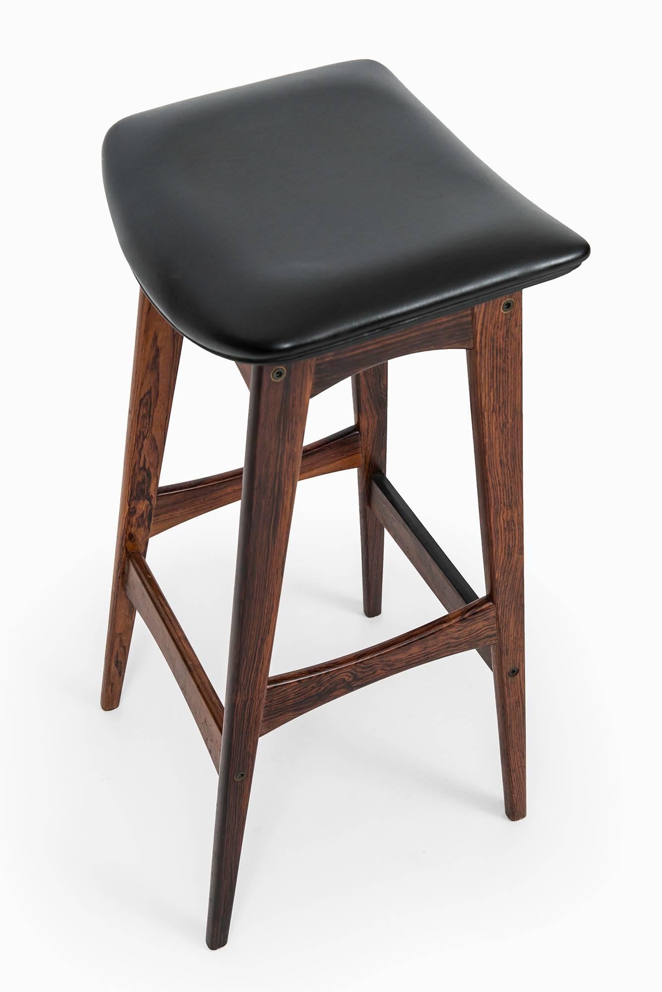 Rare set of four bar stools designed by Johannes Andersen. Produced by Brdr. Andersen in Denmark.