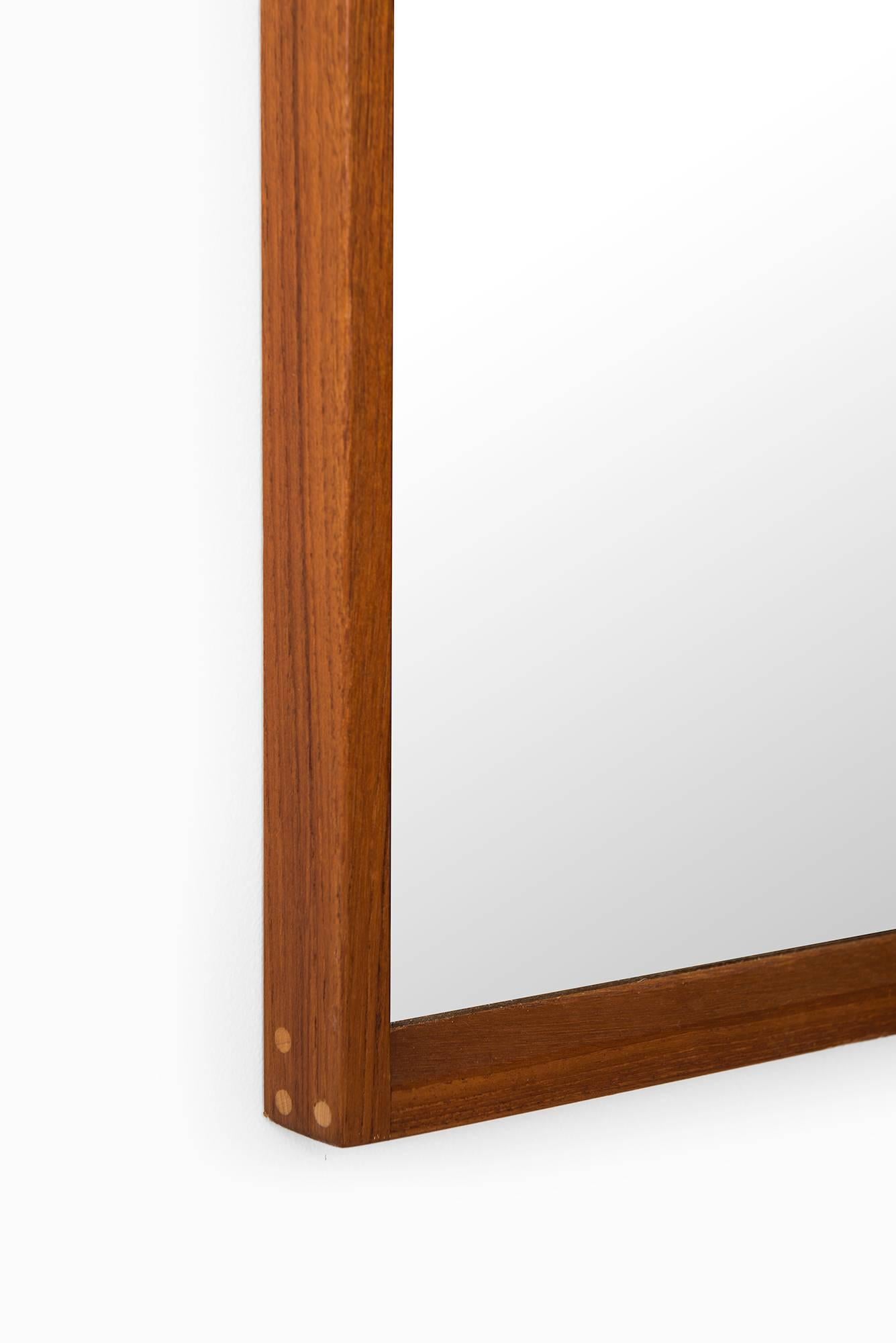 Mirror in teak designed by Aksel Kjersgaard. Produced by Odder in Denmark.
