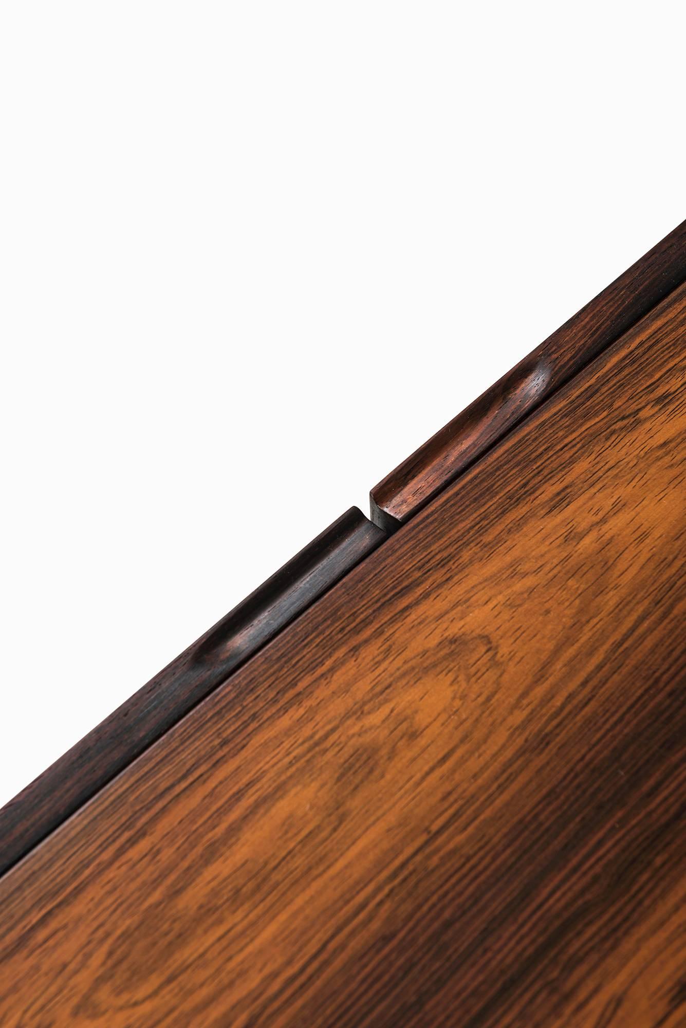 Contemporary sideboard in rosewood and steel produced in Denmark.