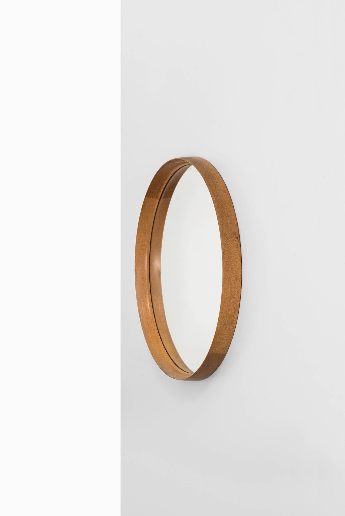 Rare and large mirror in oak designed by Uno & Östen Kristiansson. Produced by Luxus in Vittsjö, Sweden.