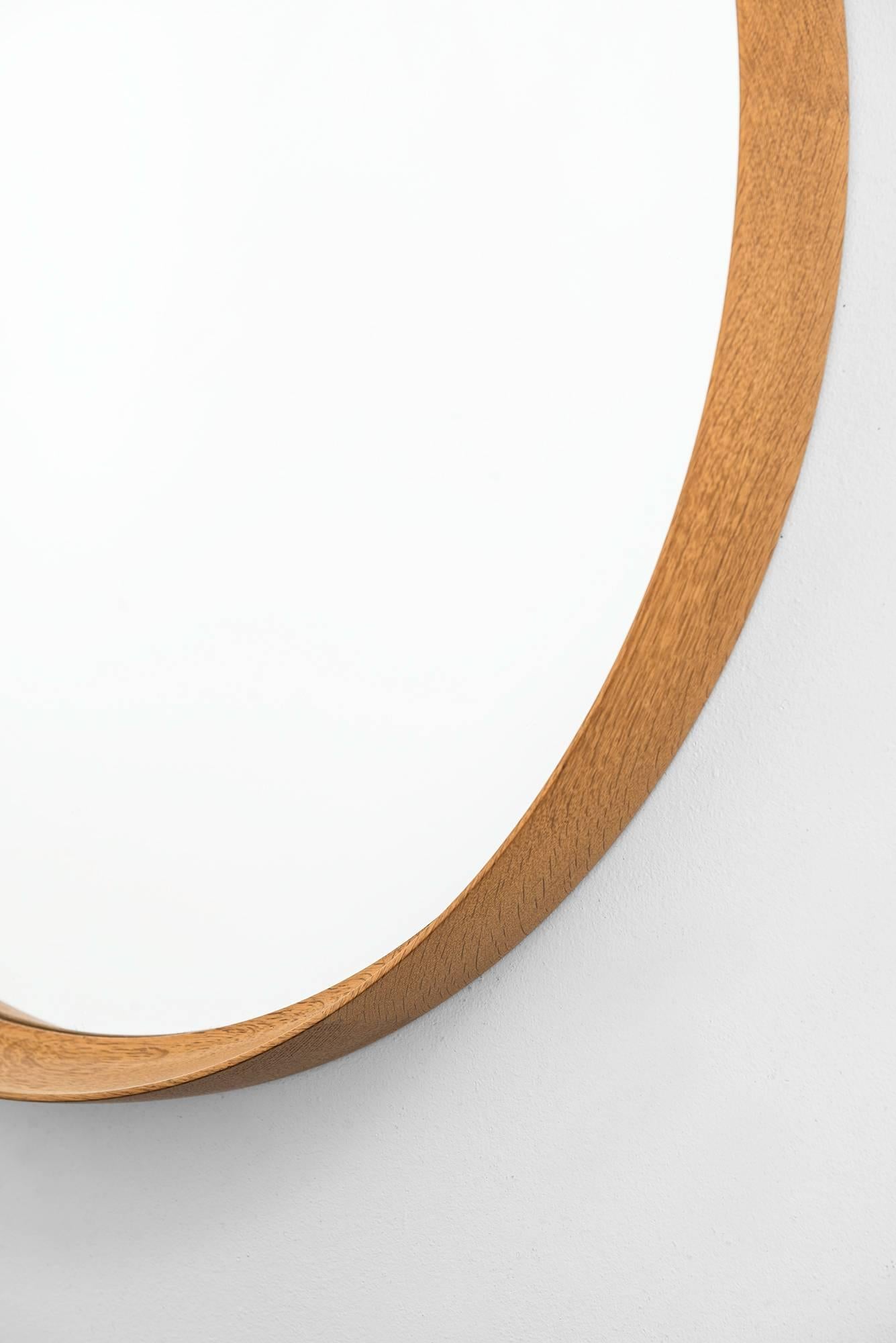Rare and large mirror in oak designed by Uno & Östen Kristiansson. Produced by Luxus in Vittsjö, Sweden.