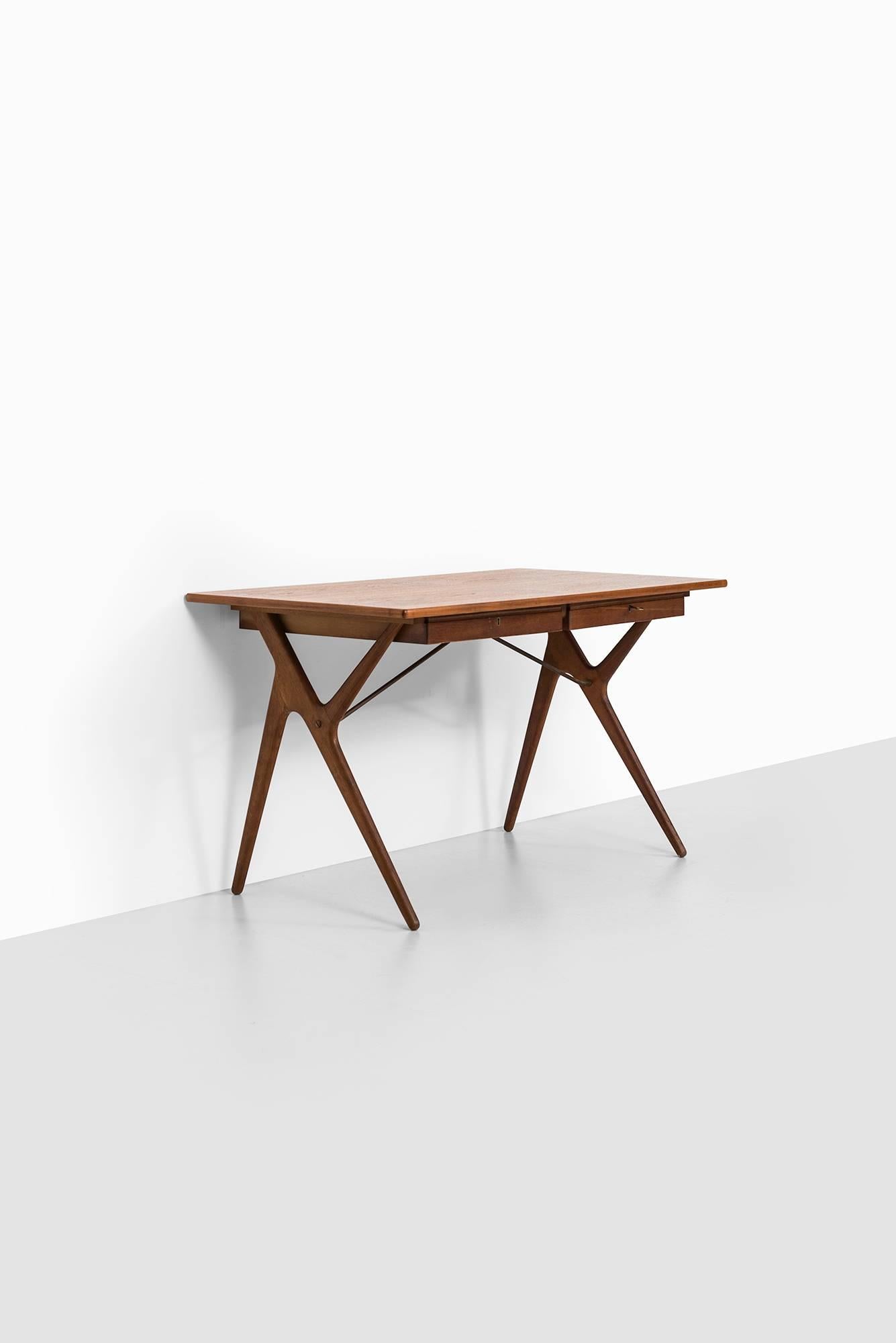 Rare desk in teak with oak legs. Produced in Denmark.