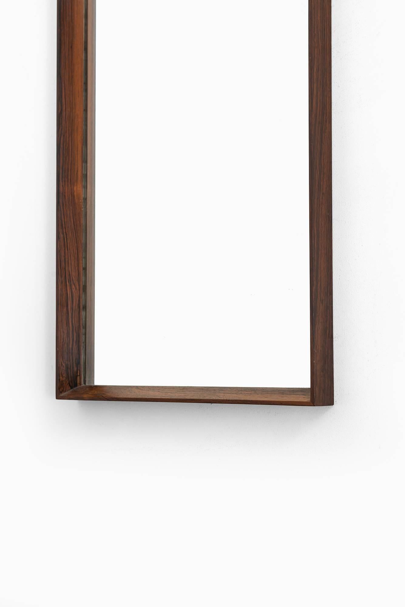 Mirror in rosewood produced in Denmark.