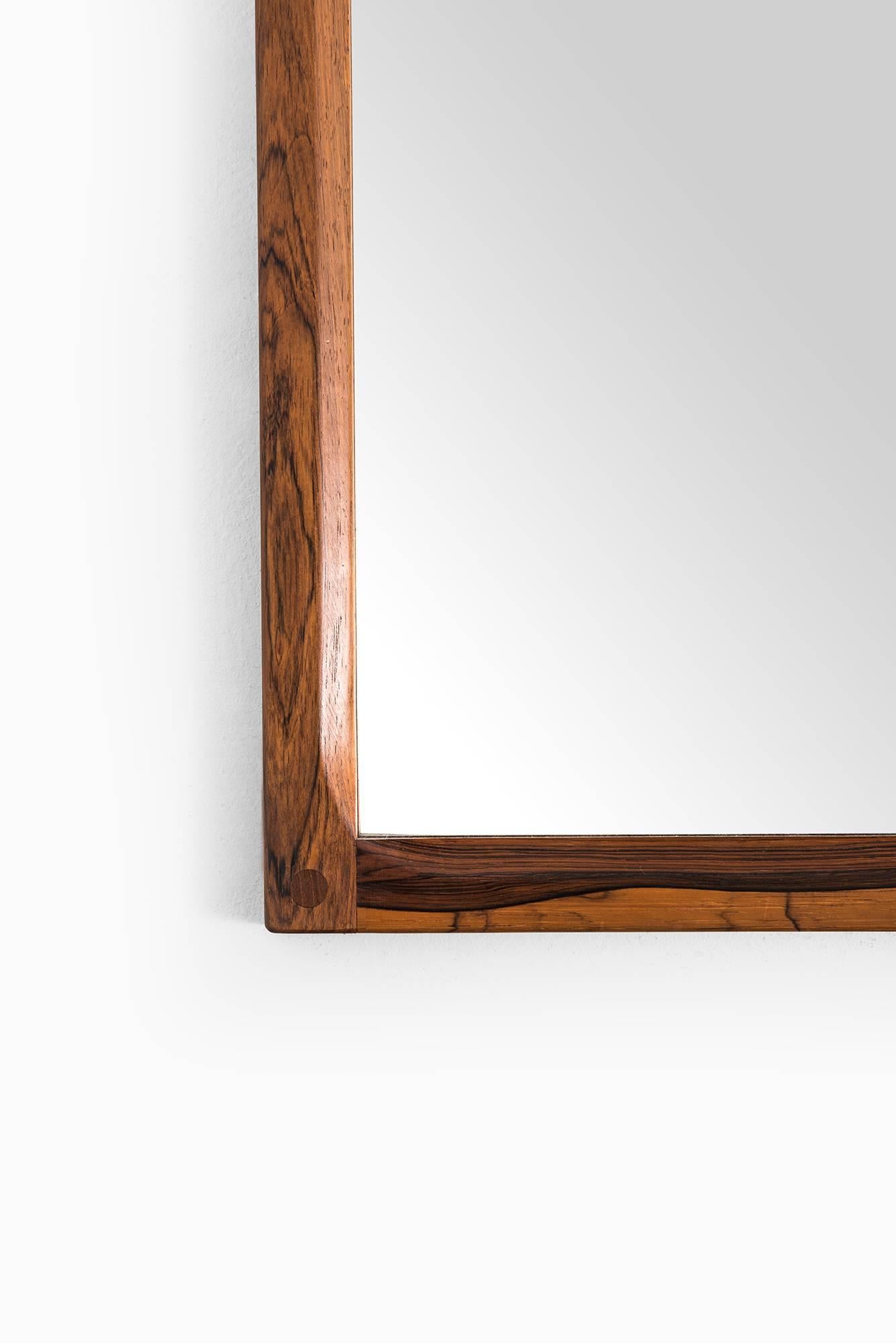 Big mirror in rosewood designed by Aksel Kjersgaard. Produced by Odder in Denmark.