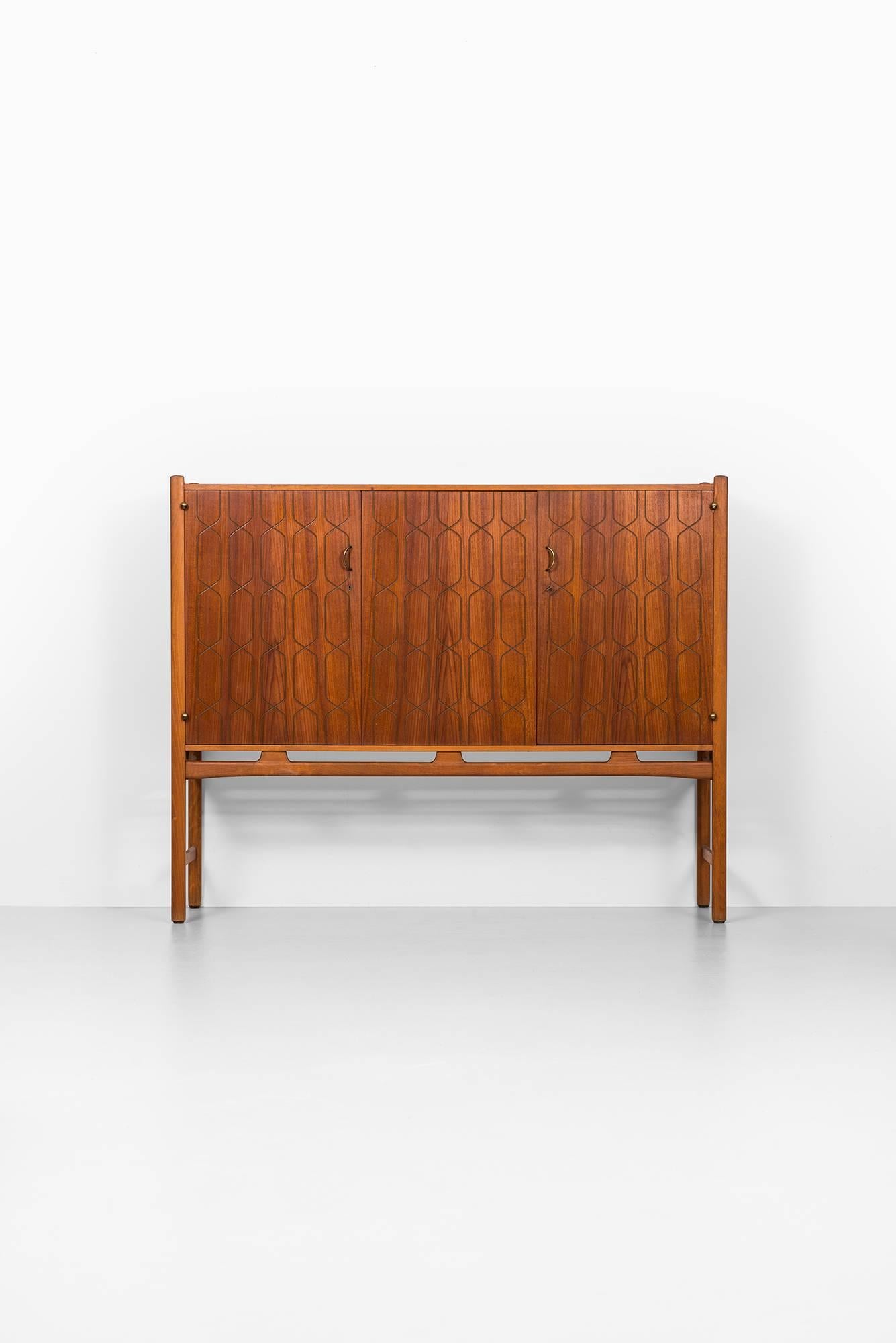 Rare cabinet in teak and mahogany designed by David Rosén. Produced by Nordiska Kompaniet in Sweden.