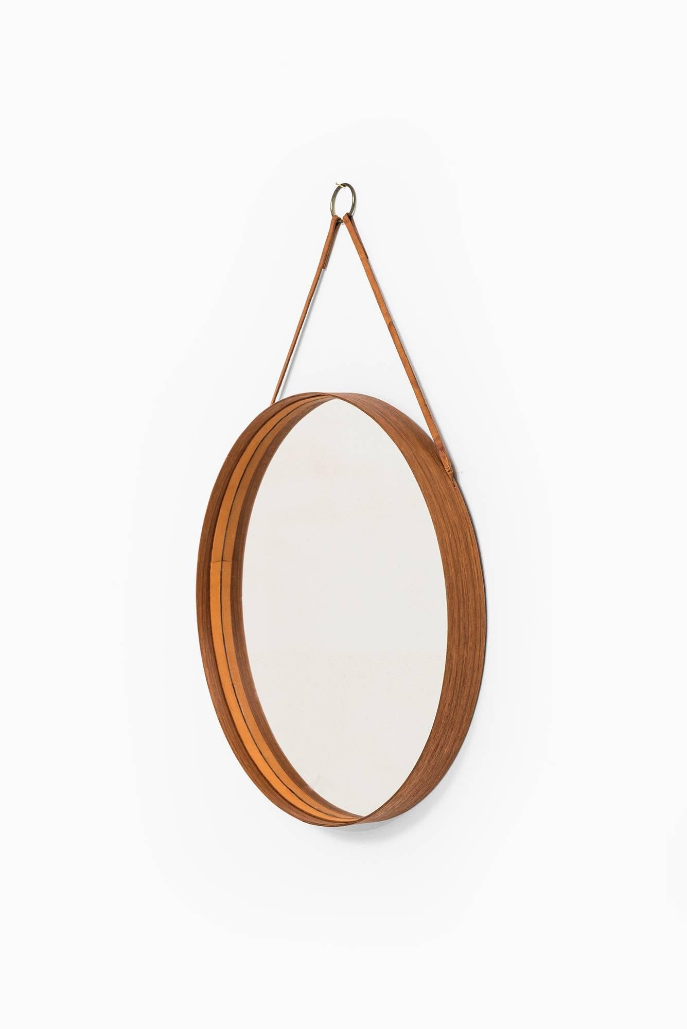 Rare mirror in teak, brass and leather. Produced by Glass mäster in Markaryd, Sweden.