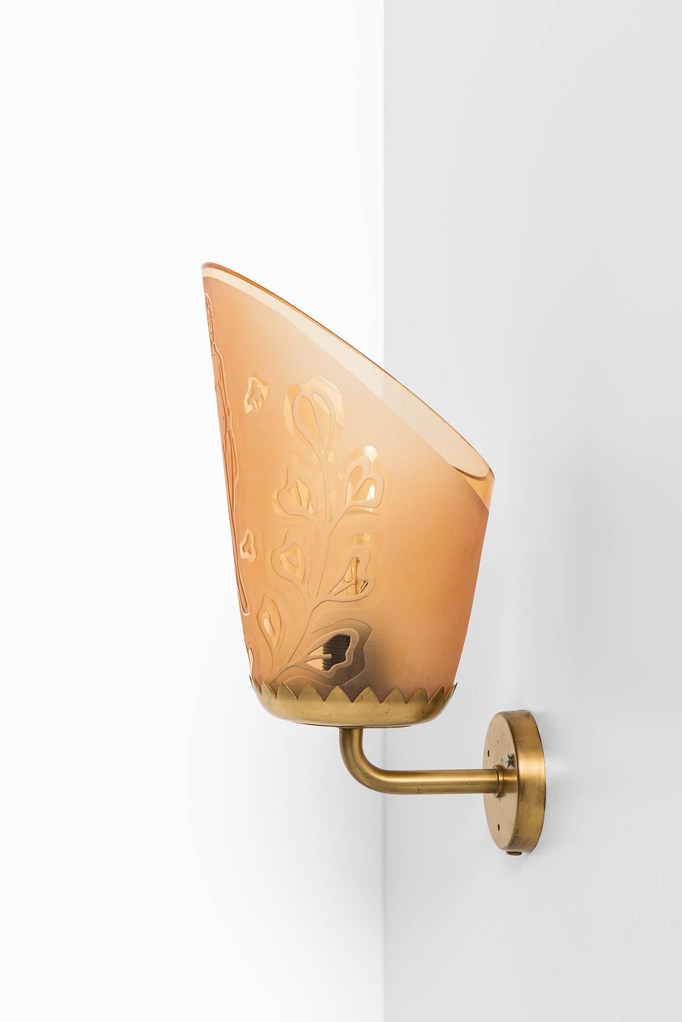Rare pair of wall lamps in brass and etched glass designed by Bo Notini. Produced by Glössner in Sweden.