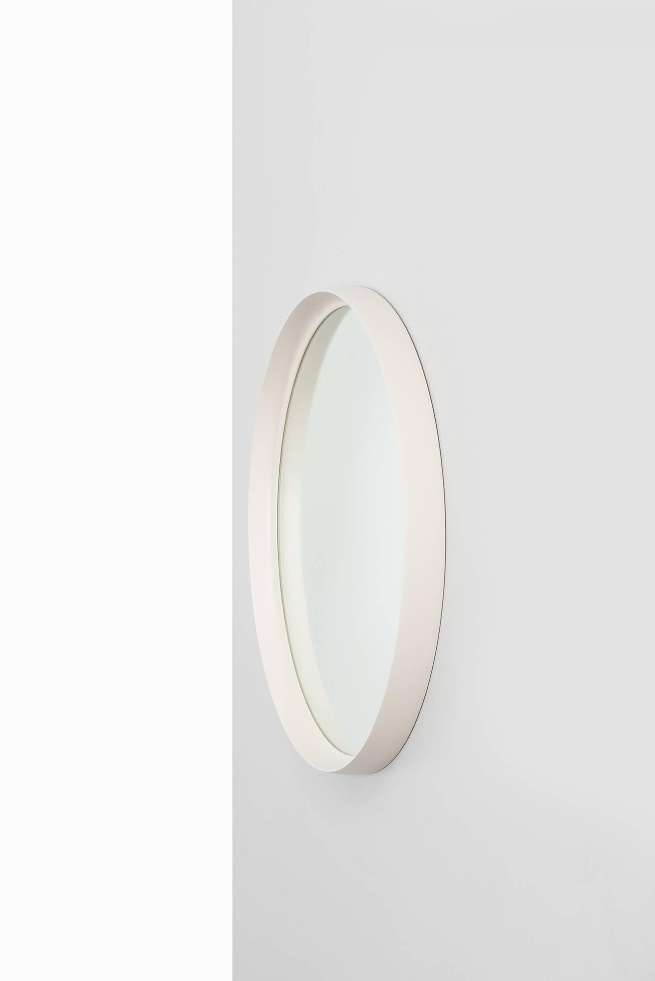 White lacquered round mirror probably produced in Sweden.