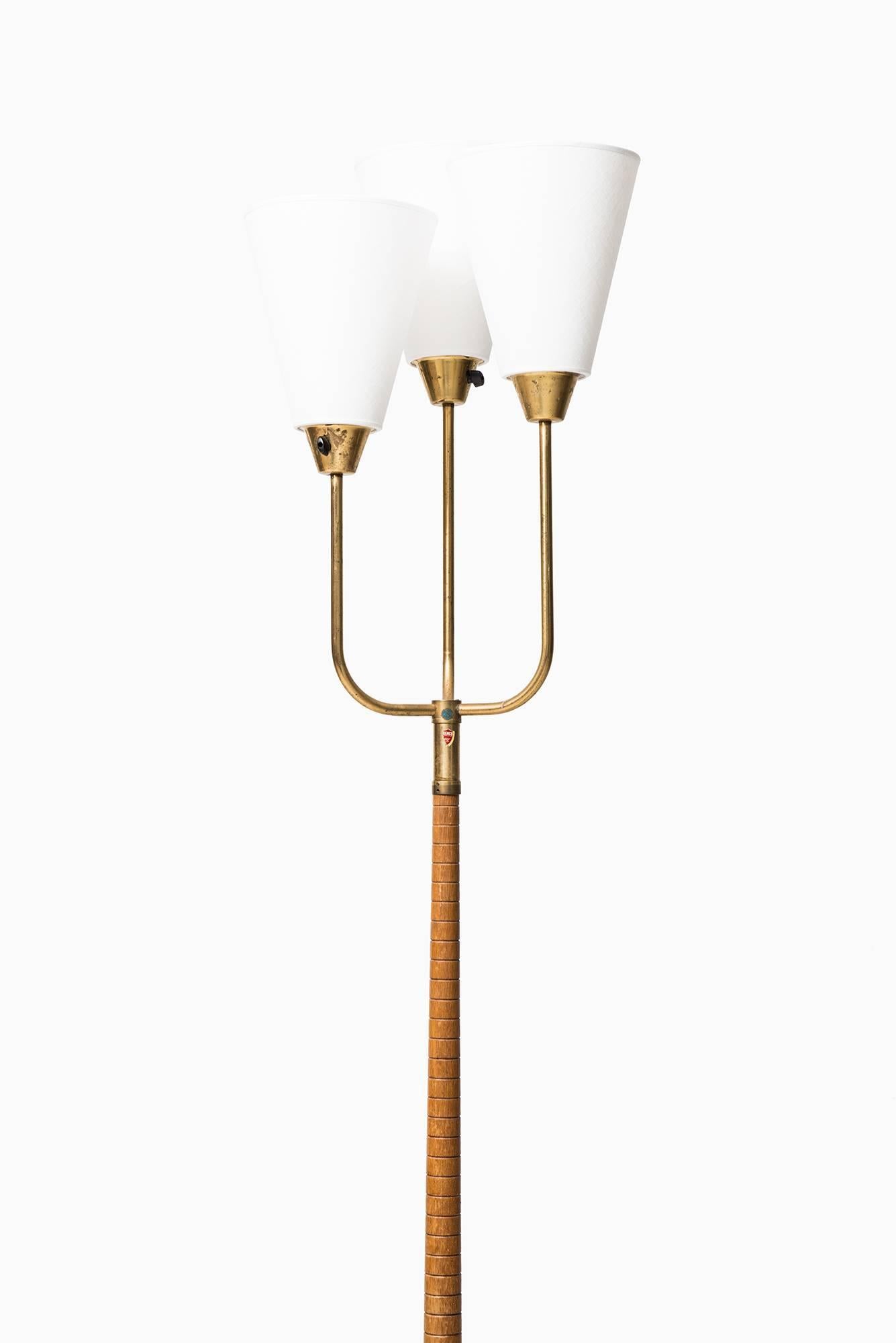 Midcentury uplight with three arms produced in Sweden.