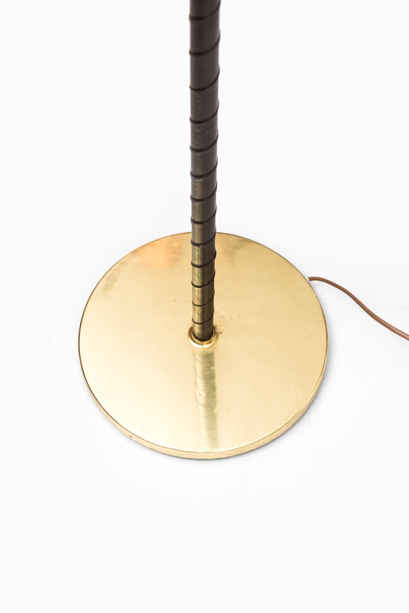 Scandinavian Modern Floor Lamp in Black Leather, Brass and Woven Cane Shade Produced in Sweden