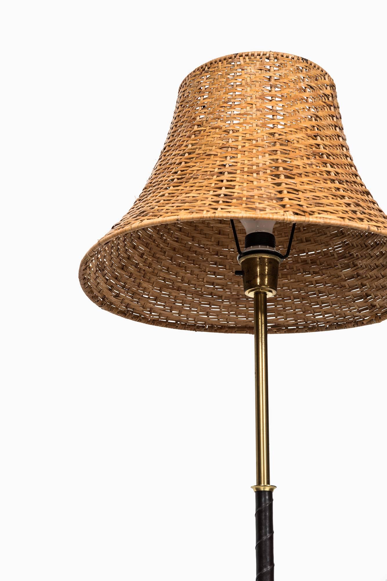 Swedish Floor Lamp in Black Leather, Brass and Woven Cane Shade Produced in Sweden