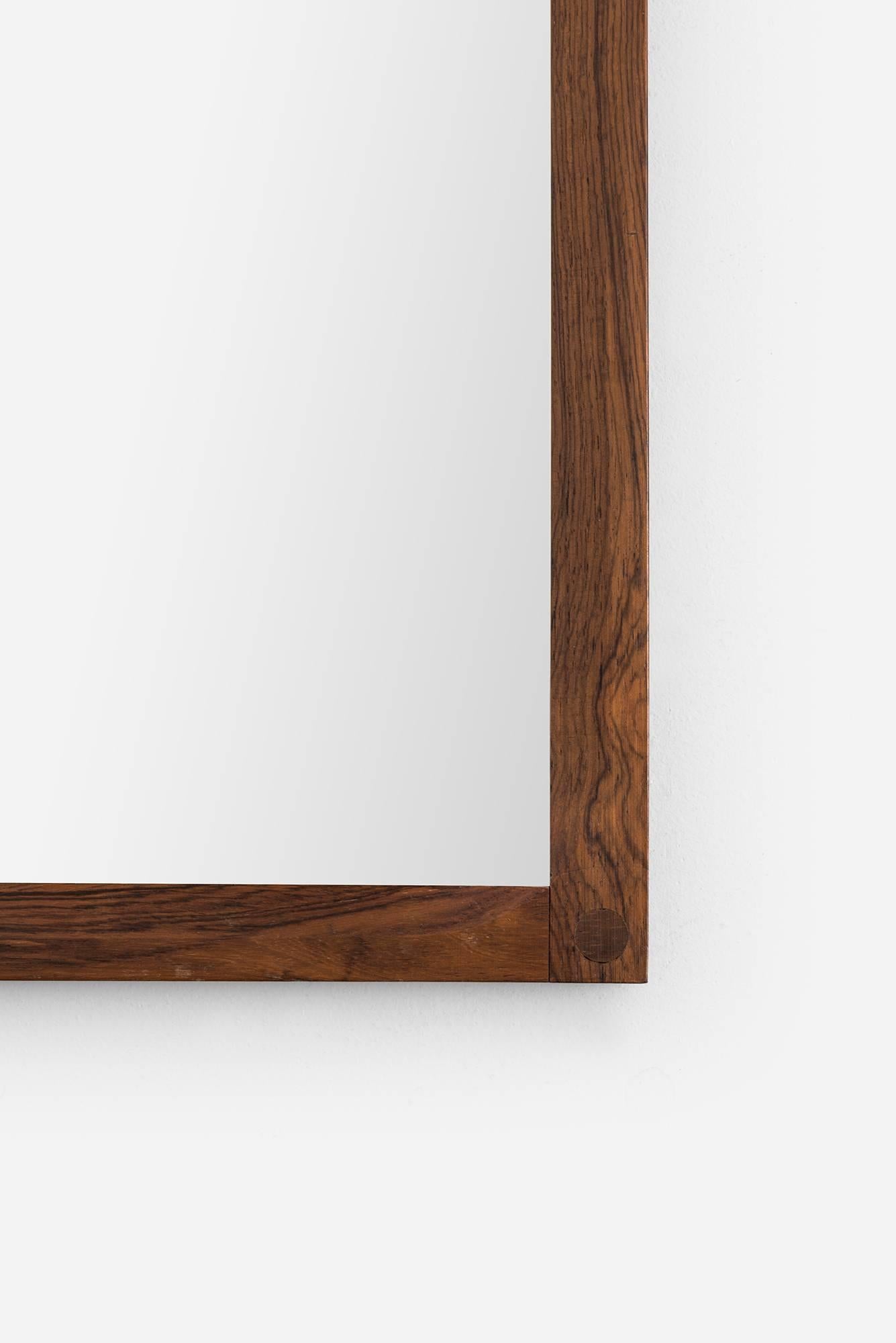 Mirror in rosewood designed by Aksel Kjersgaard. Produced by Odder in Denmark.